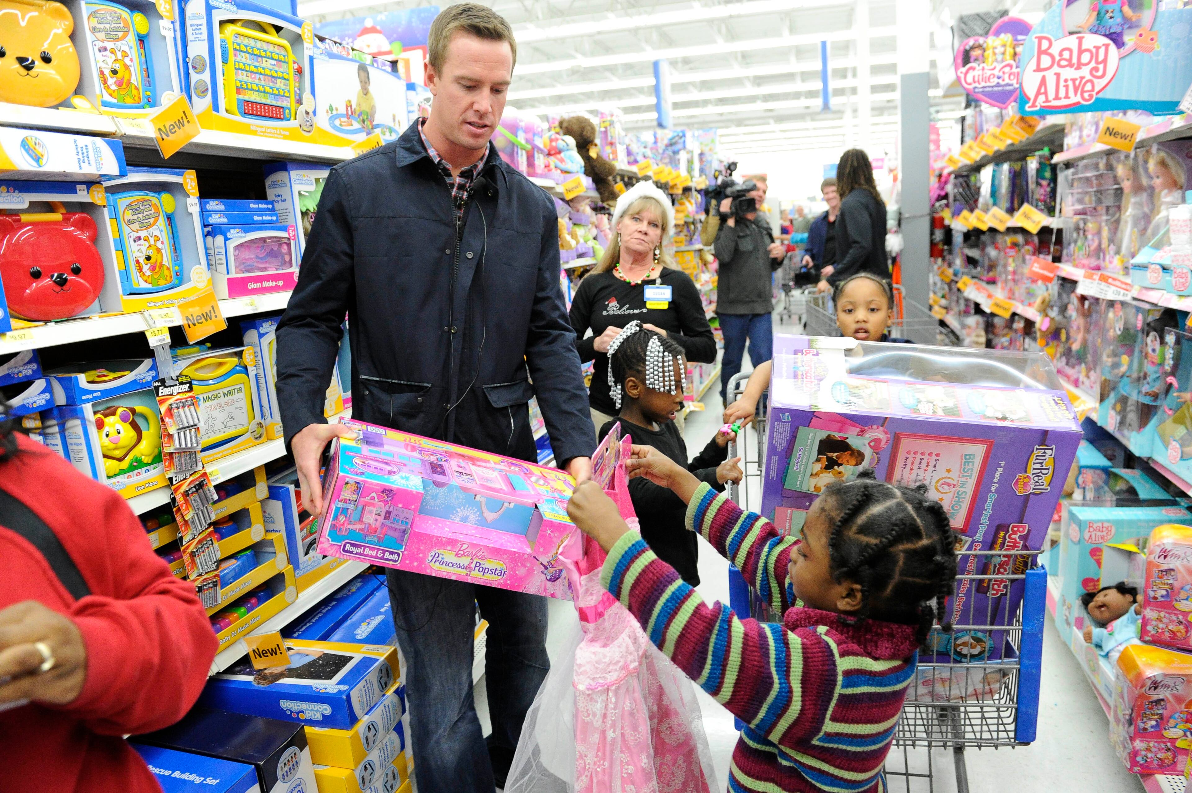 NFL quarterback for the Atlanta Falcons Matt Ryan helps kids shop at Wal-Mart Tuesday, Dec. 11, 2012, in Suwanee. The Falcons players were participating in the program "Shop with a Jock" in which they provided children from an Atlanta are mission with a $100 gift card in merchandise.
