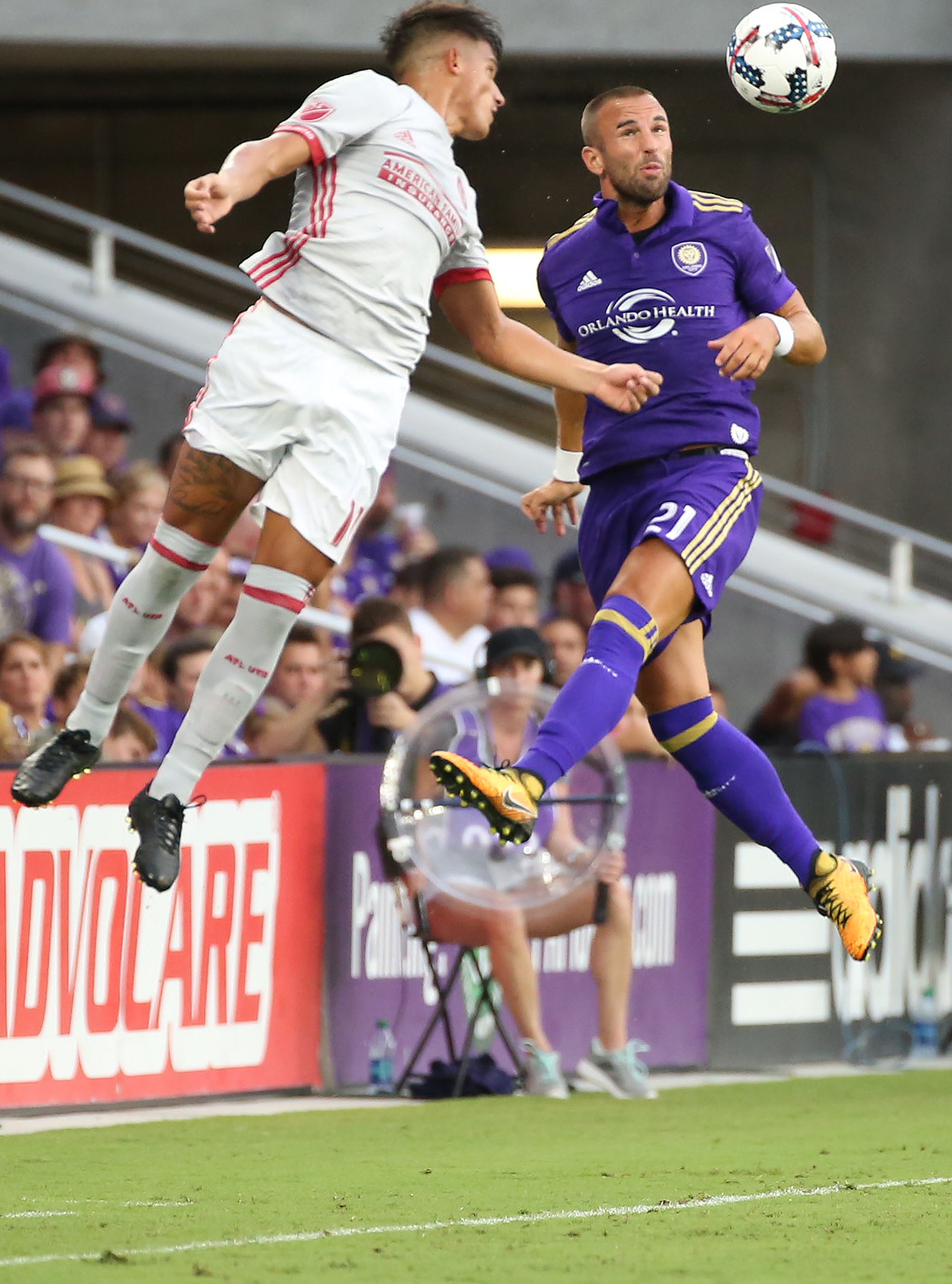 Atlanta United's Yamil Asad (11) and Orlando City's Scott Sutter (21) leap for the ball during action at Orlando City Stadium on Friday, July 21, 2017, in Orlando, Fla. (Stephen M. Dowell/Orlando Sentinel/TNS)