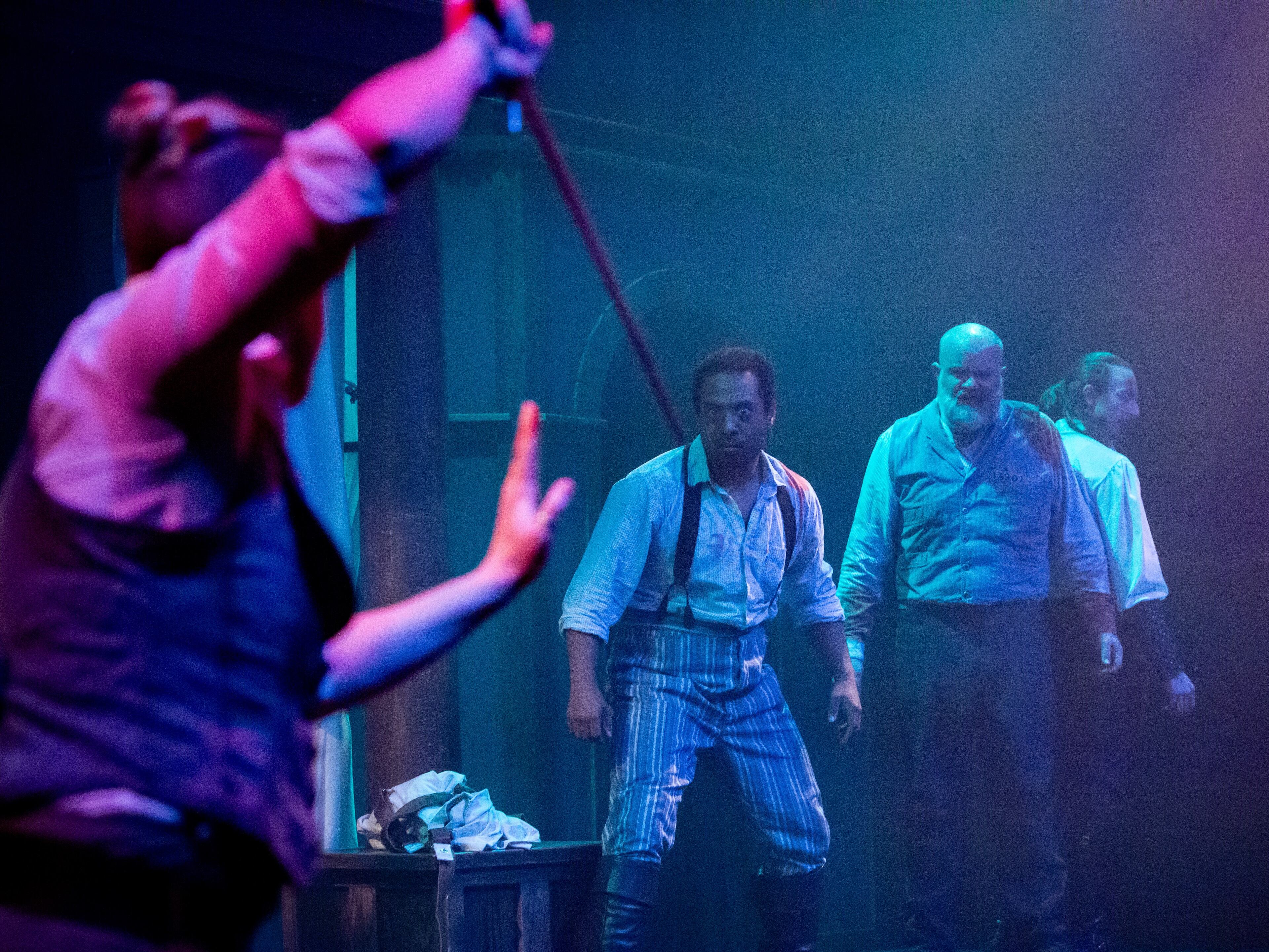 Swordplay has a role in this very physical version of the Dracula story. From left, Dr. Van Helsing (Mary Ruth Ralston) faces Dr. John Seward (Daryel T. Monson), Renfield (Vinnie Mascola) and (Dracula Benedetto Robinson). Photo: Jeffrey Watkins