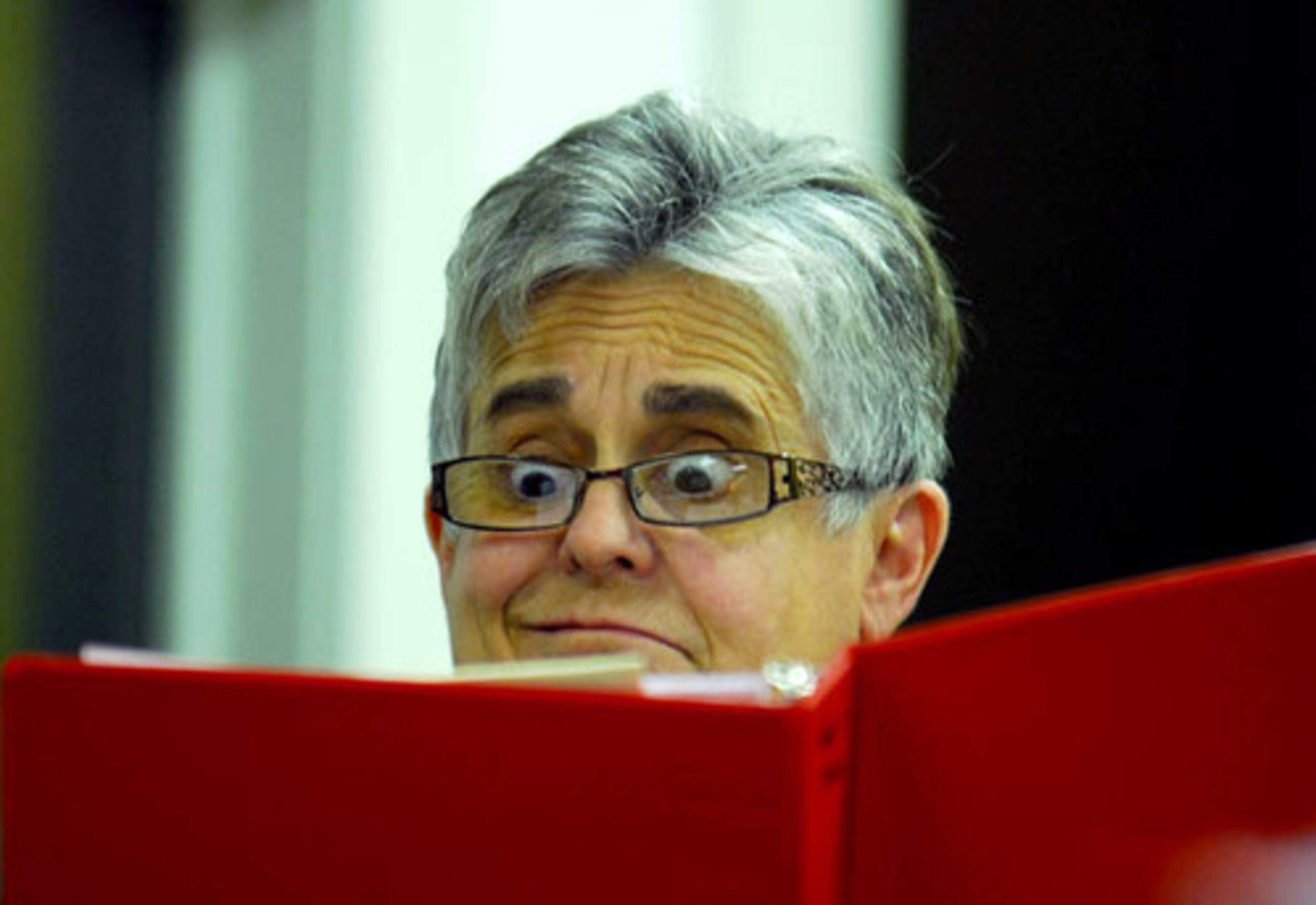 Ruth Roser, an alto for the St. Dunstan's Episcopal church choir, takes a look at the sheet music for "In the Garden, " an original choral piece by composer James Stevenson.
