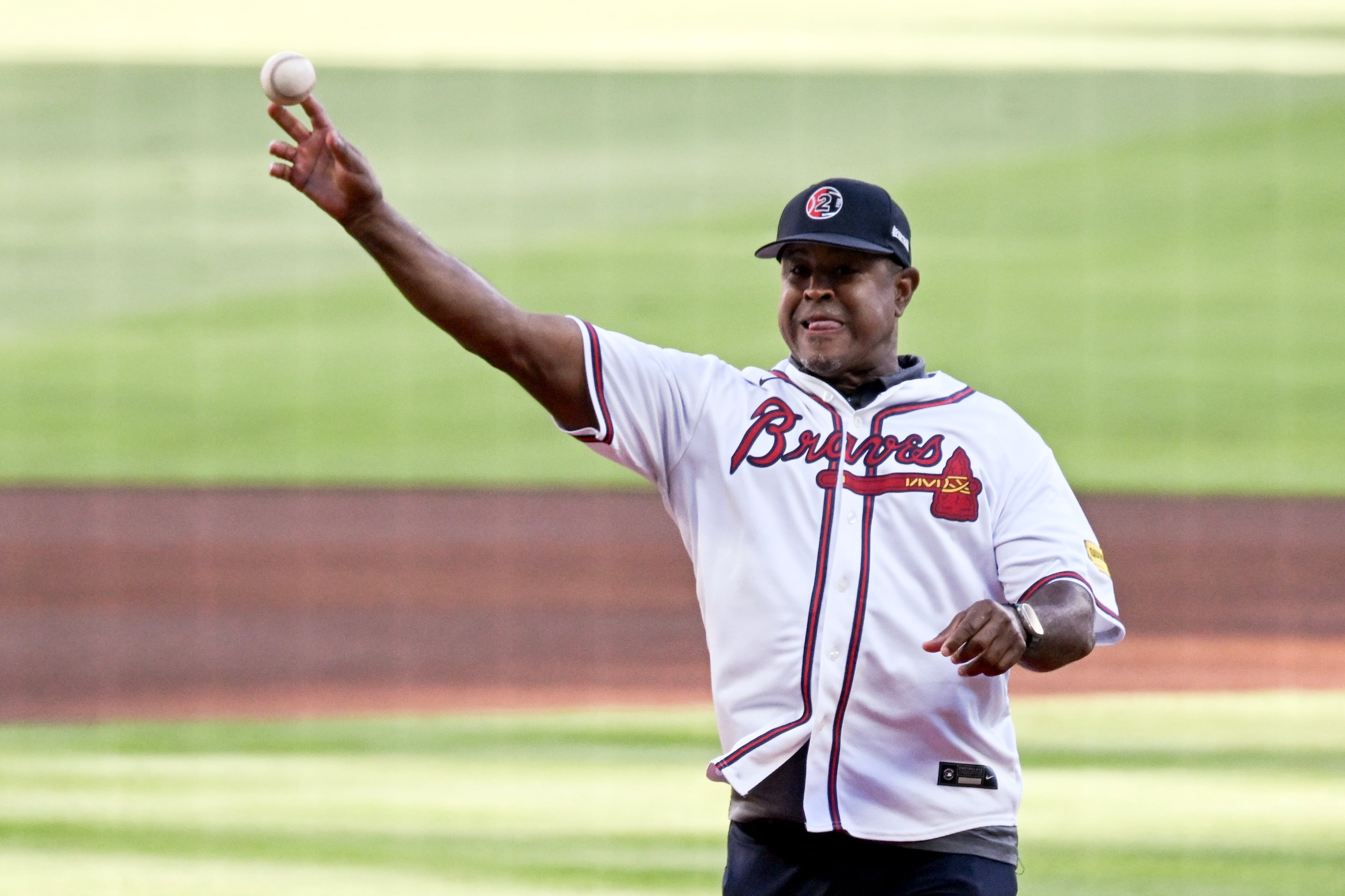 Former Atlanta Braves player Brian Jordan throws out the ceremonial first pitch before Game 3 of the MLB National League Division Series between the Atlanta Braves and the Los Angeles Dodgers, Tuesday, Oct. 6, 2026, in Atlanta. (Hyosub Shin/AJC)