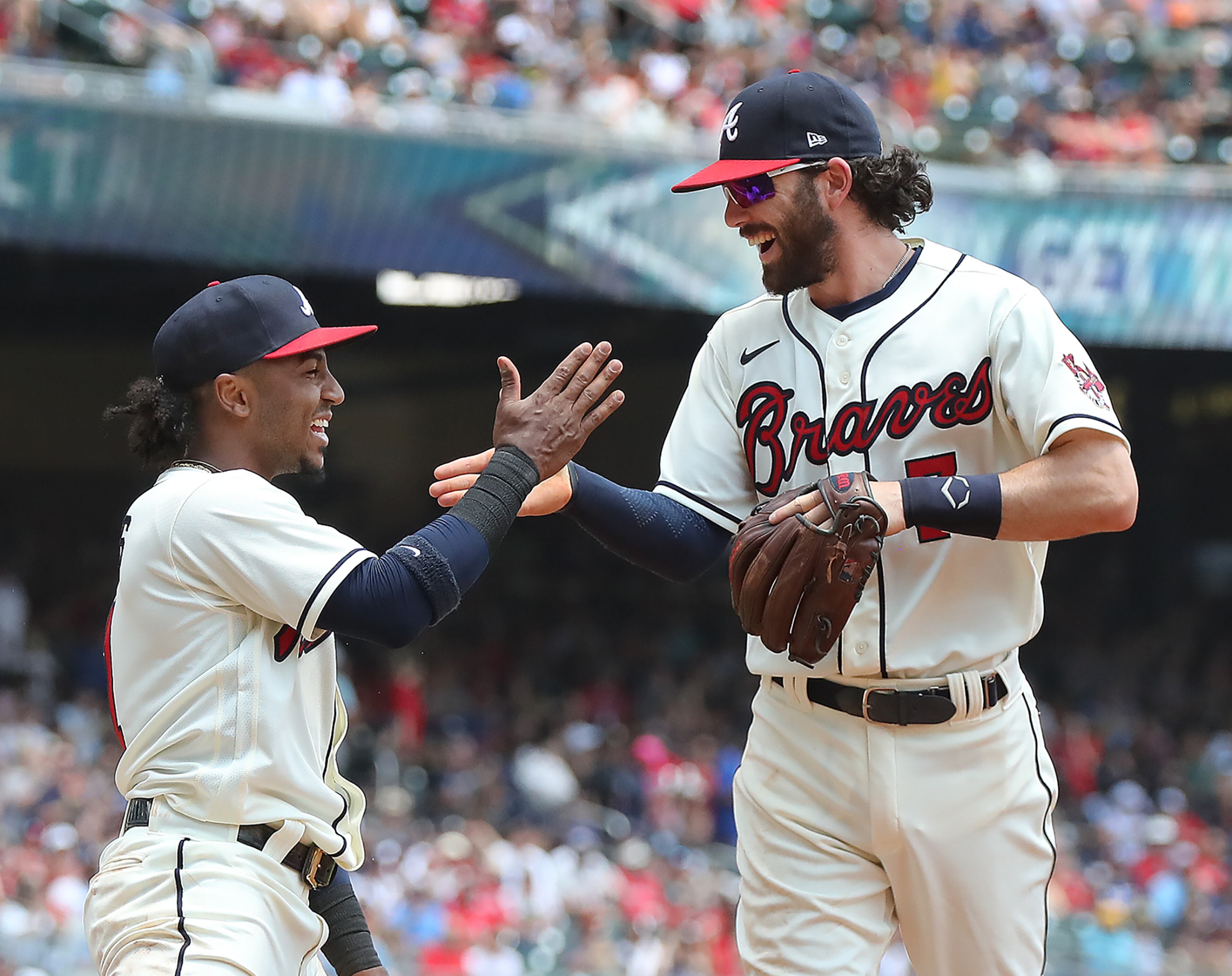 Braves second baseman Ozzie Albies (left) and shortstop Dansby Swanson celebrate turning a double play against the Pittsburgh Pirates on a bunt during the second inning. Albies covered first base after Freddie Freeman moved up to play the bunt and throw to second Sunday, May 23, 2021, at Truist Park in Atlanta. (Curtis Compton / Curtis.Compton@ajc.com)