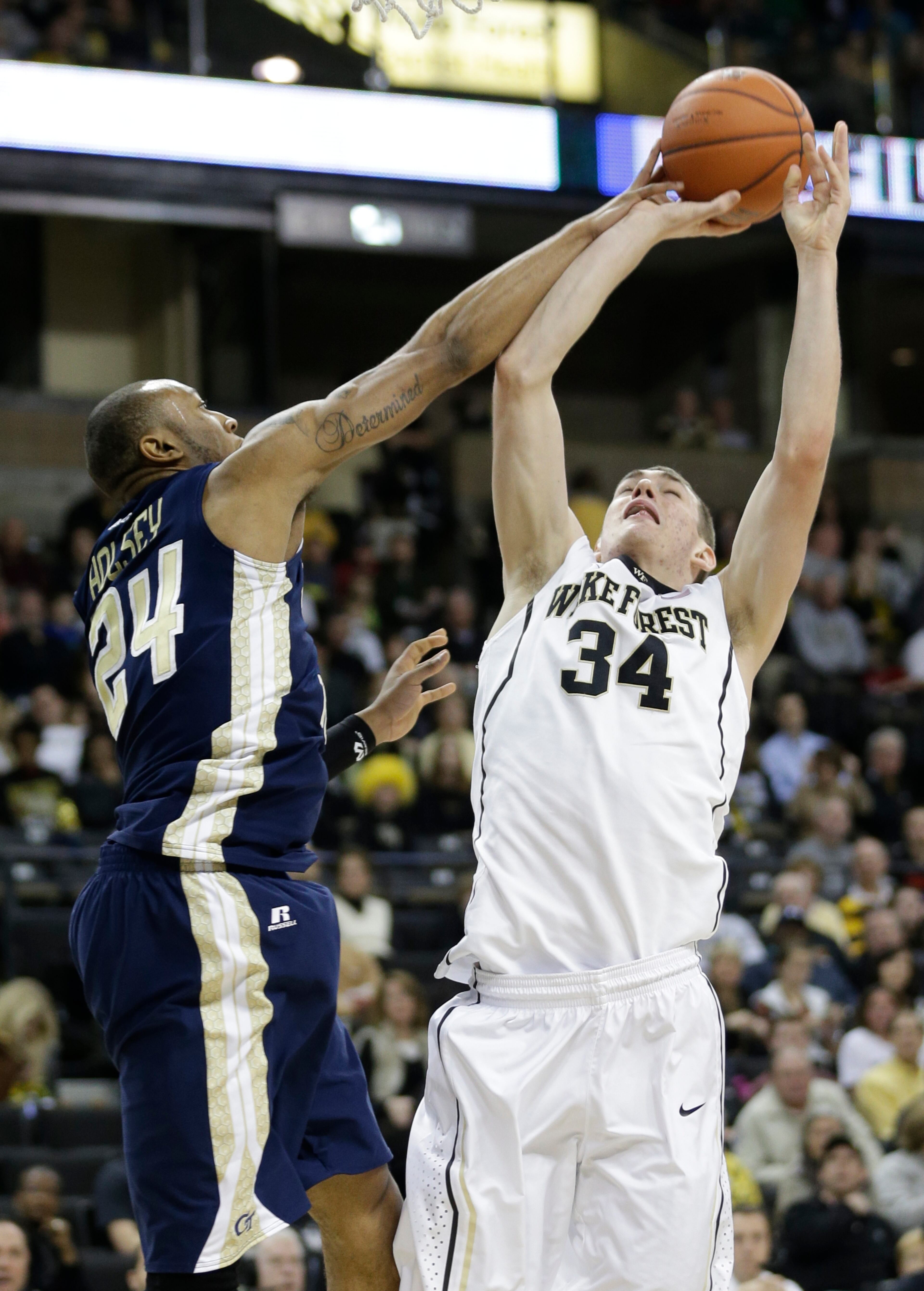 Wake Forest's Tyler Cavanaugh (34) shoots over Georgia Tech's Kammeon Holsey (24) during the first half of an NCAA college basketball game in Winston-Salem, N.C., Saturday, Feb. 1, 2014.