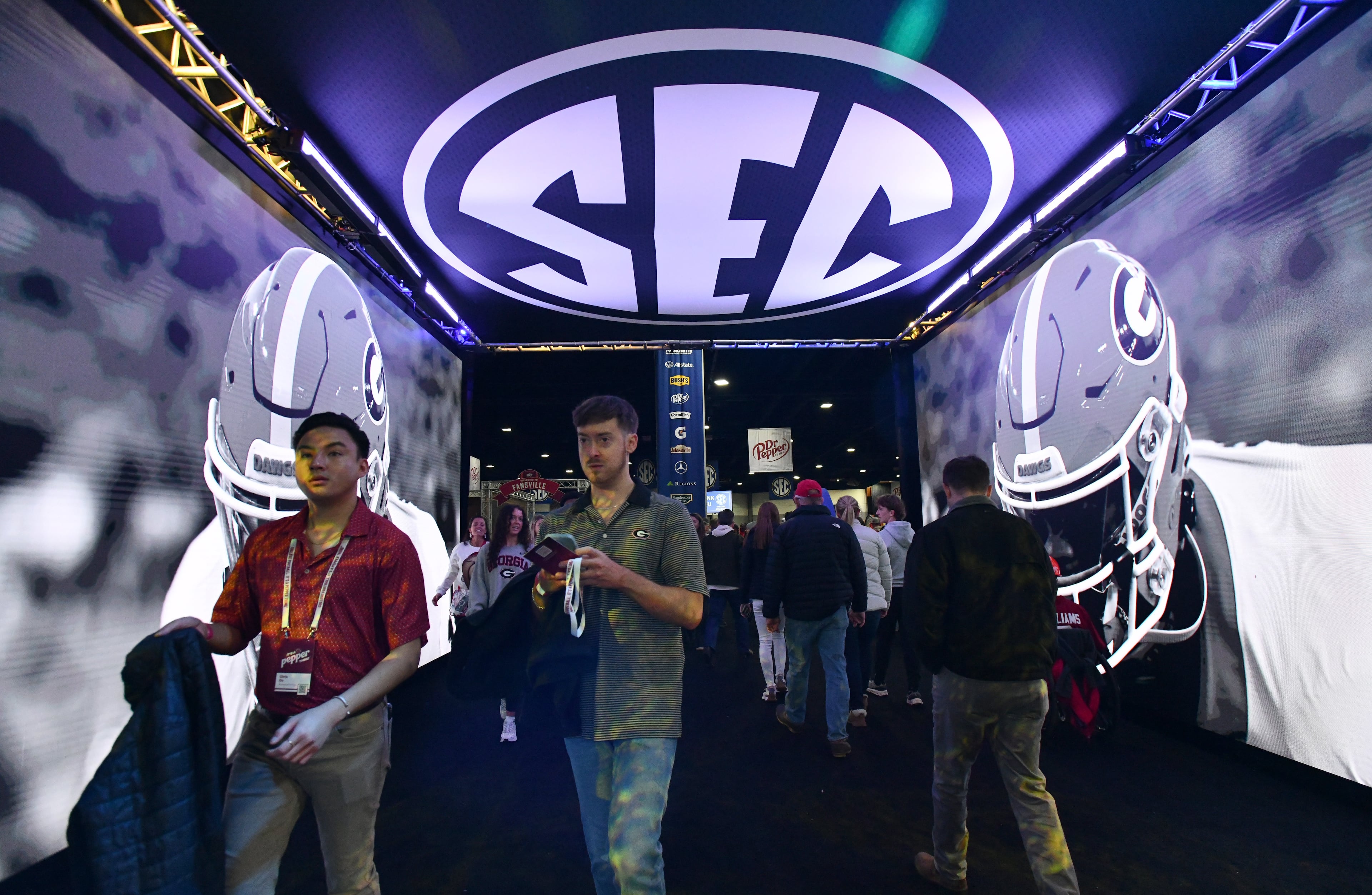 Fans enter The Dr Pepper SEC FanFare ahead of the SEC Championship football game between Georgia and Alabama, Saturday, Dec. 6, 2025 in Atlanta. (Hyosub Shin/AJC)