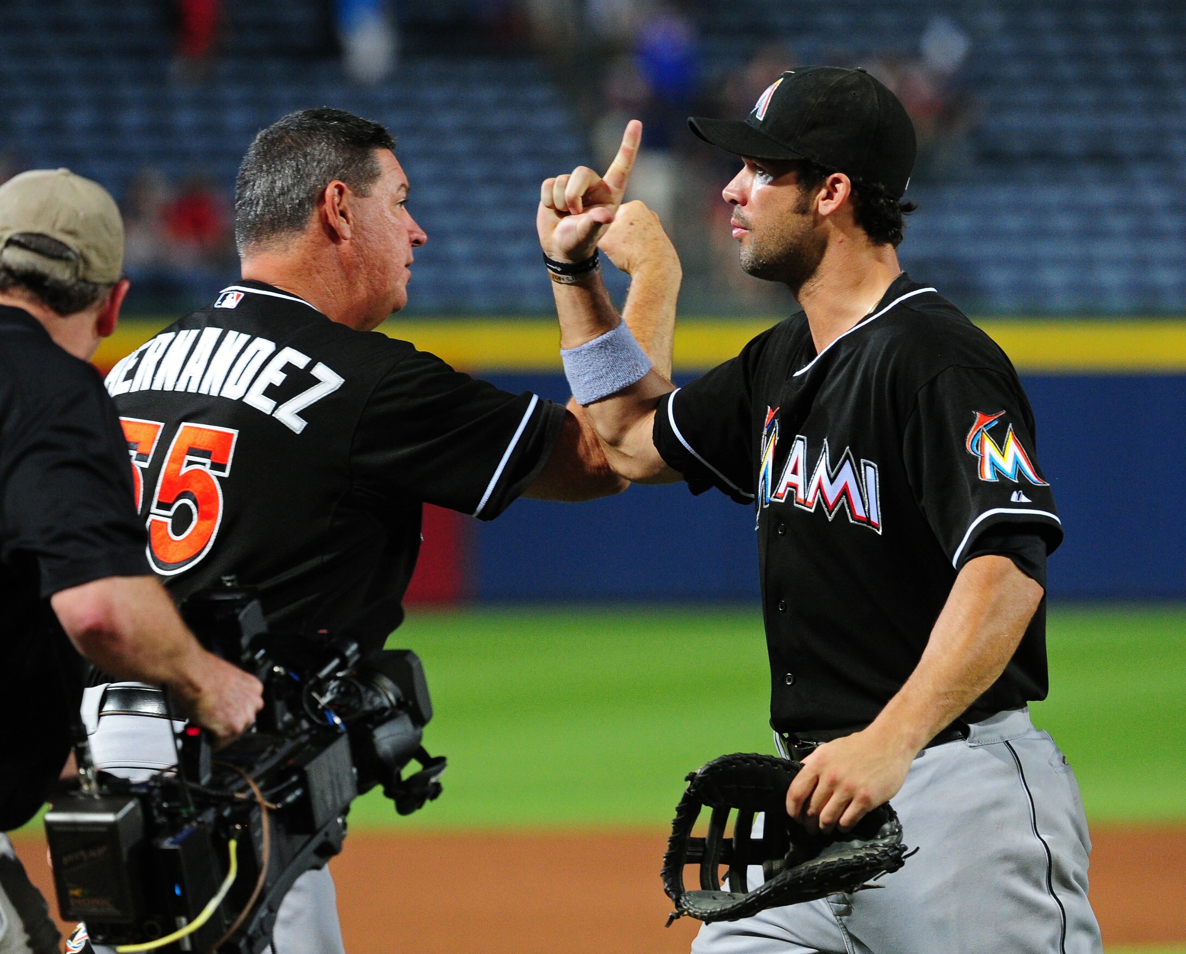 ATLANTA, GA - JULY 21: Garrett Jones #46 and pitching coach Chuck Hernandez #55 of the Miami Marlins celebrate after the game against the Atlanta Braves at Turner Field on July 21, 2014 in Atlanta, Georgia. (Photo by Scott Cunningham/Getty Images)