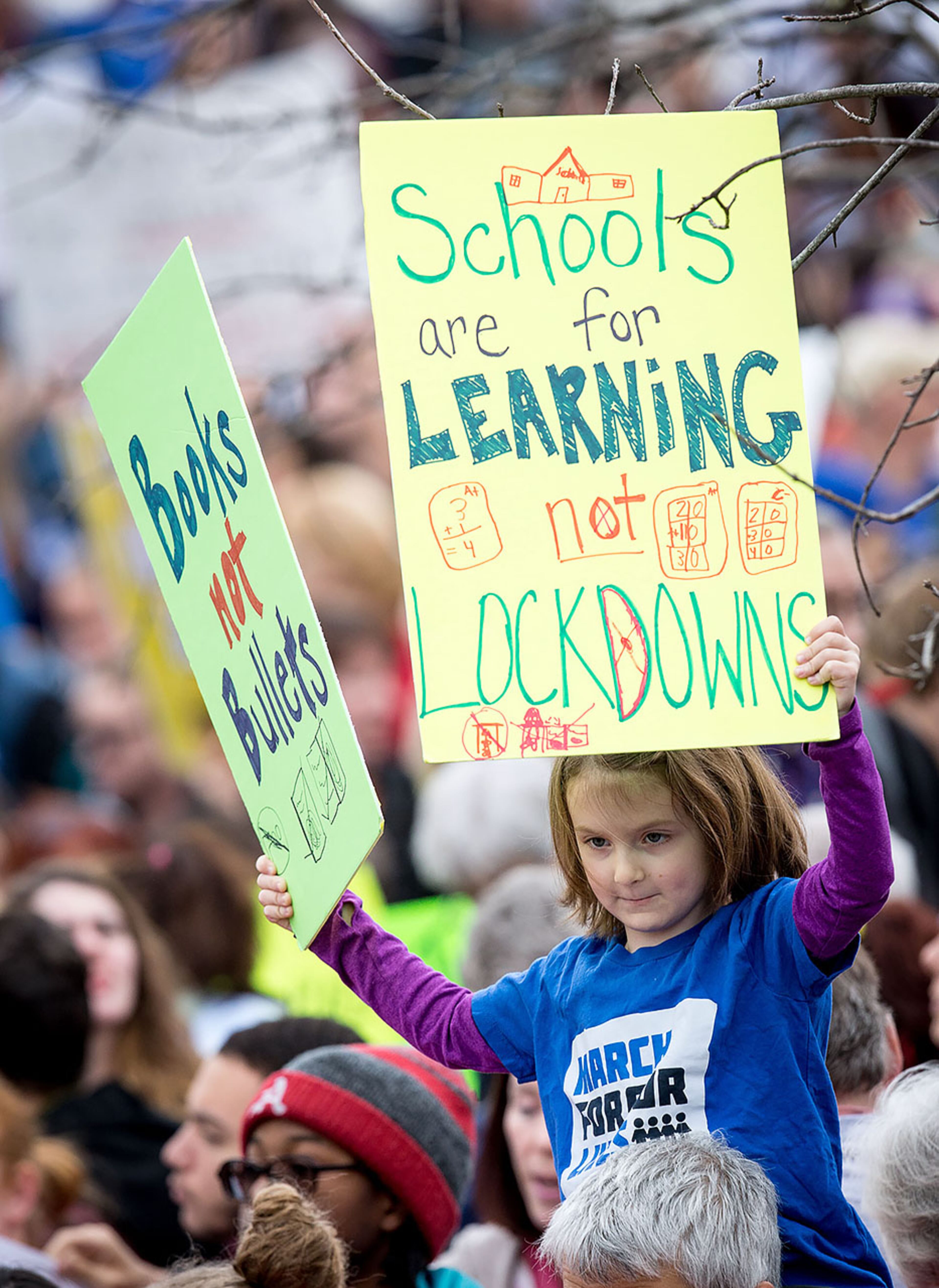 Cate Zeigler-Amon, 7, holds up signs at the start of the March For Our Life Atlanta rally in Atlanta GA Saturday, March 24, 2018. STEVE SCHAEFER / SPECIAL TO THE AJC