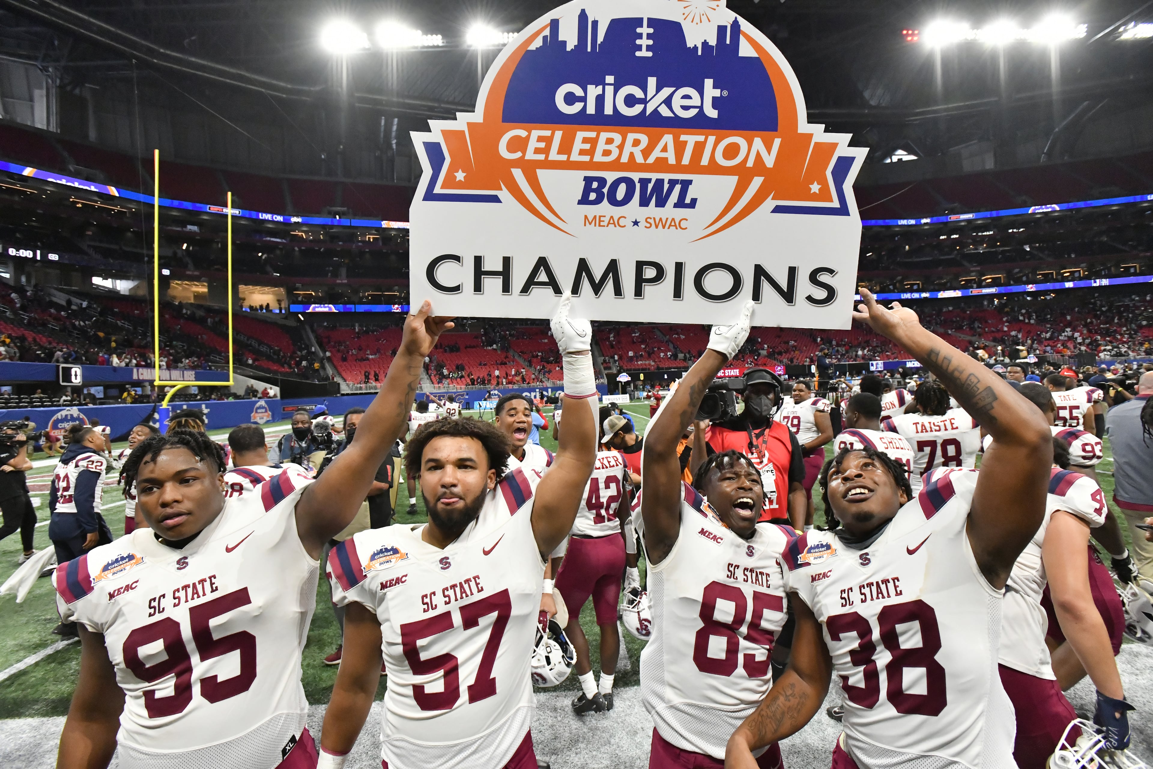 South Carolina State players celebrate winning the 2021 Cricket Celebration Bowl at Mercedes-Benz Stadium in Atlanta on Saturday, December 18, 2021. South Carolina State won 31-10 over Jackson State. (Hyosub Shin / Hyosub.Shin@ajc.com)