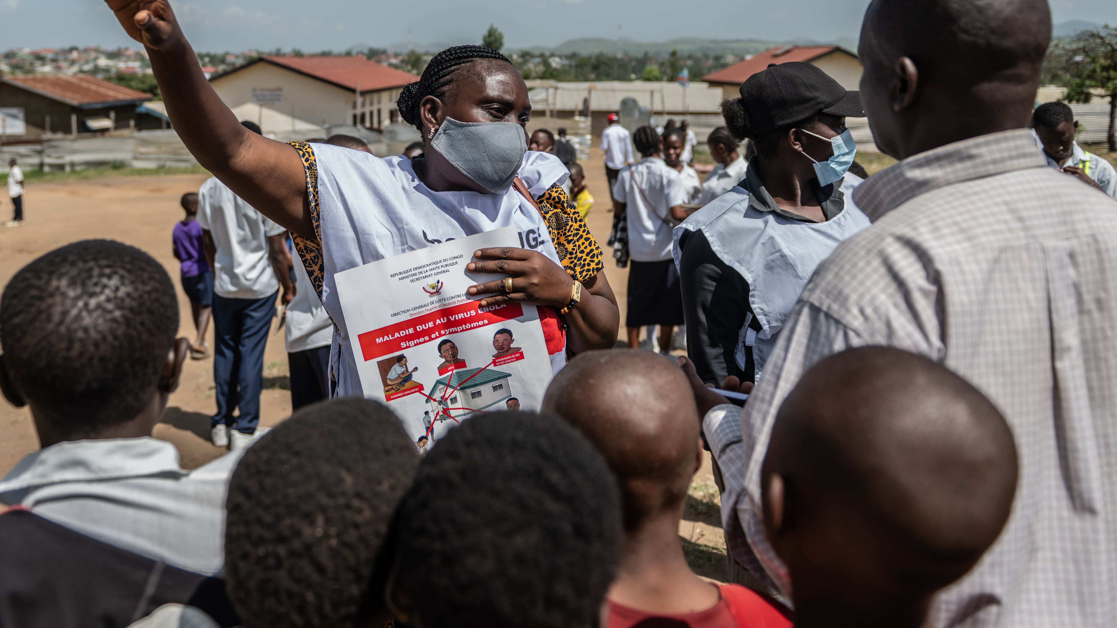 Vanny Birungi, a Red Cross volunteer, speaks to people during a public sensitisation campaign amid the Ebola outbreak in Bunia, Congo, Monday, May 25, 2026. (AP Photo/Moses Sawasawa)