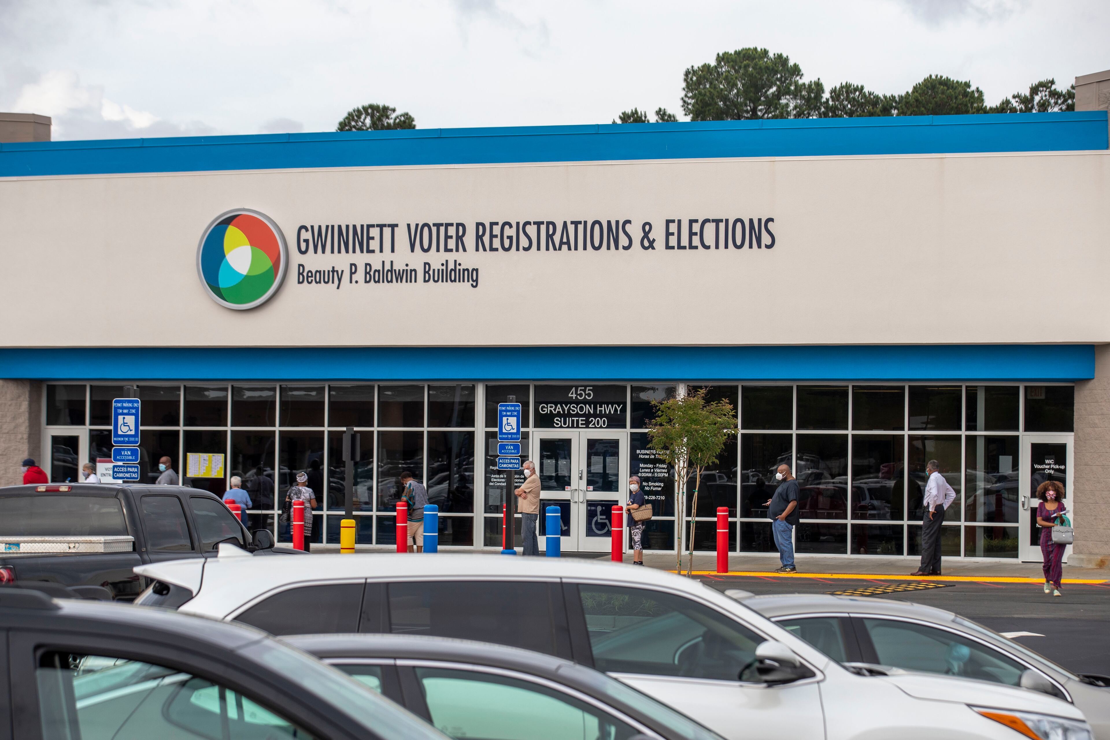05/18/2020 - Lawrenceville, Georgia - Voters participate in social distancing as they wait for access for early in-person voting at the Gwinnett County Voter Registration and Elections Office in Lawrenceville, Monday, May 18, 2020. Early voting began May 18 and will last three-weeks, ended June 5. Georgia's Election Day is Tuesday, June 9.(ALYSSA POINTER / ALYSSA.POINTER@AJC.COM)