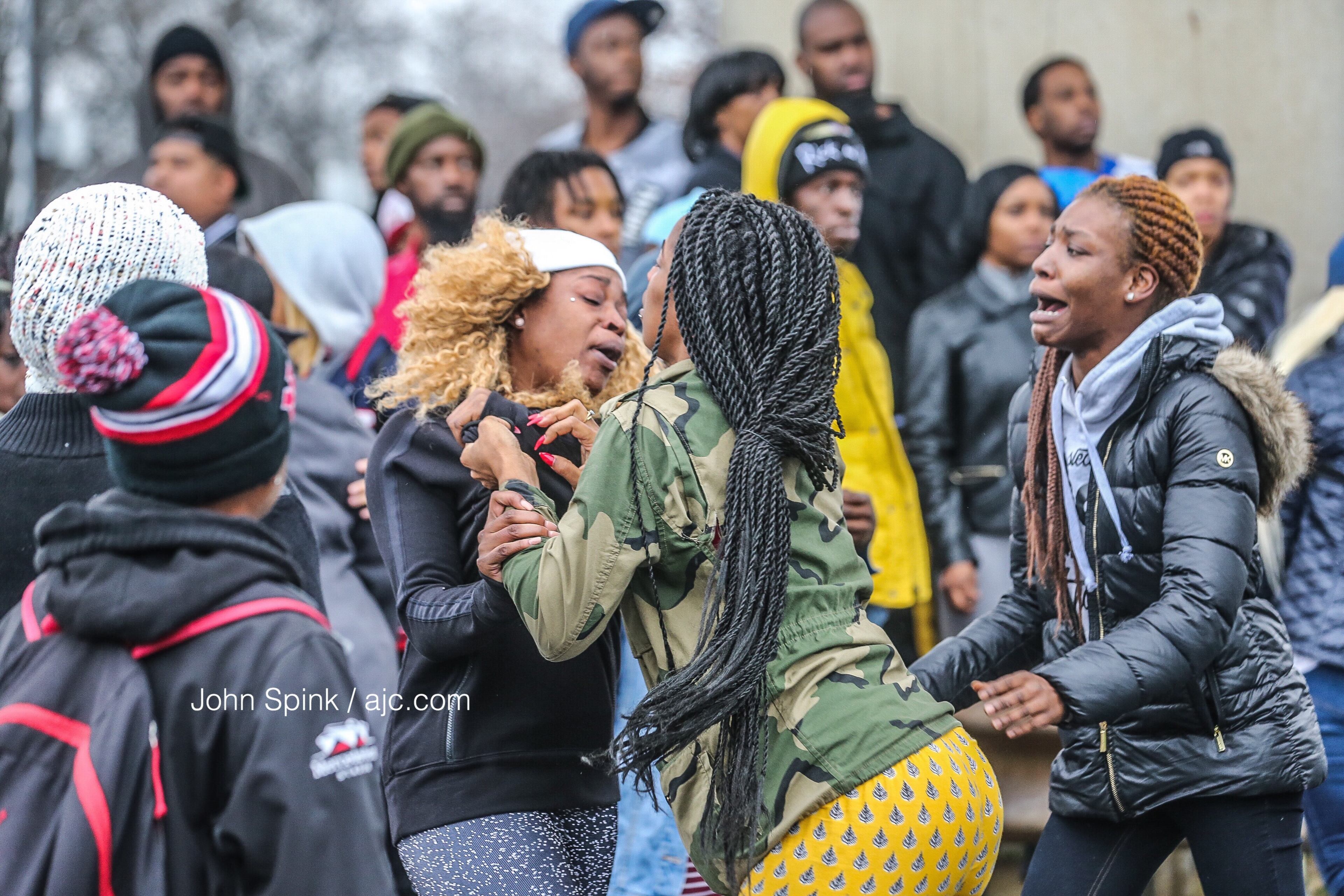 Dozens of people showed at to the scene, and some got into an altercation. JOHN SPINK / JSPINK@AJC.COM