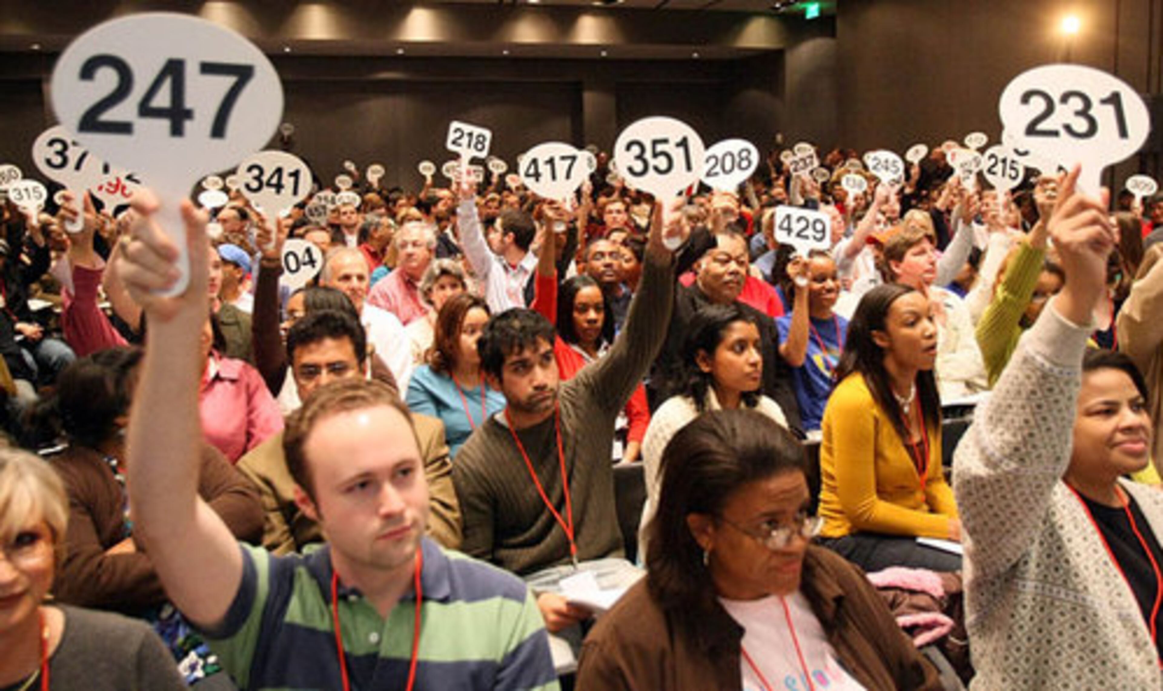 How do you sell more than 40 condos in a building in a few hours? Auction them. On Saturday, Accelerated Marketing Partners sold 44 units at the Element at Atlantic Station. Here, bidders hold up their cards as an exercise before the start of the auction.