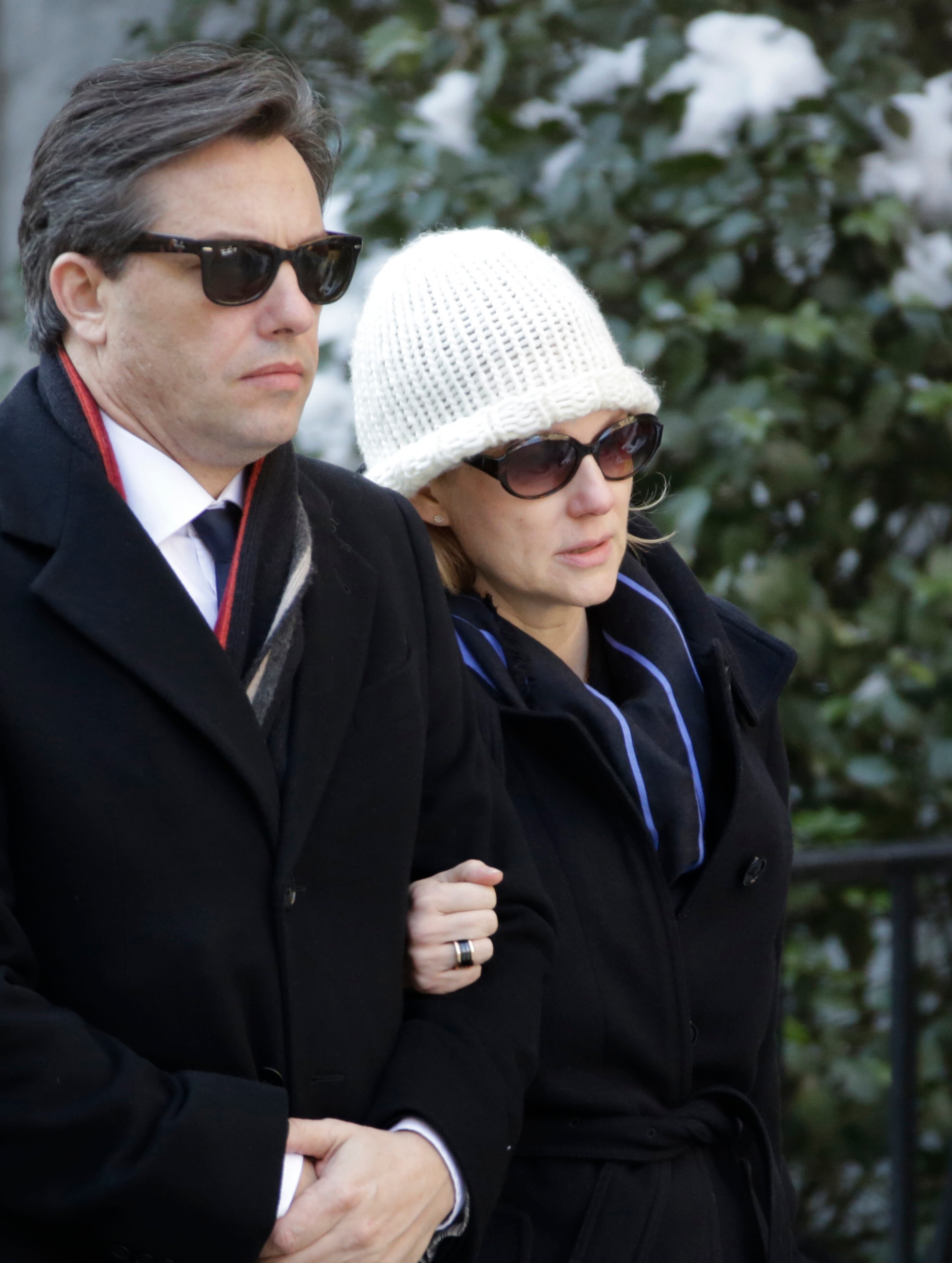 Laura Linney, right, and Marc Schauer arrive for the funeral of actor Philip Seymour Hoffman at the Church of St. Ignatius Loyola, Friday, Feb. 7, 2014 in New York. Hoffman, 46, was found dead Sunday of an apparent heroin overdose. (AP Photo/Mark Lennihan)