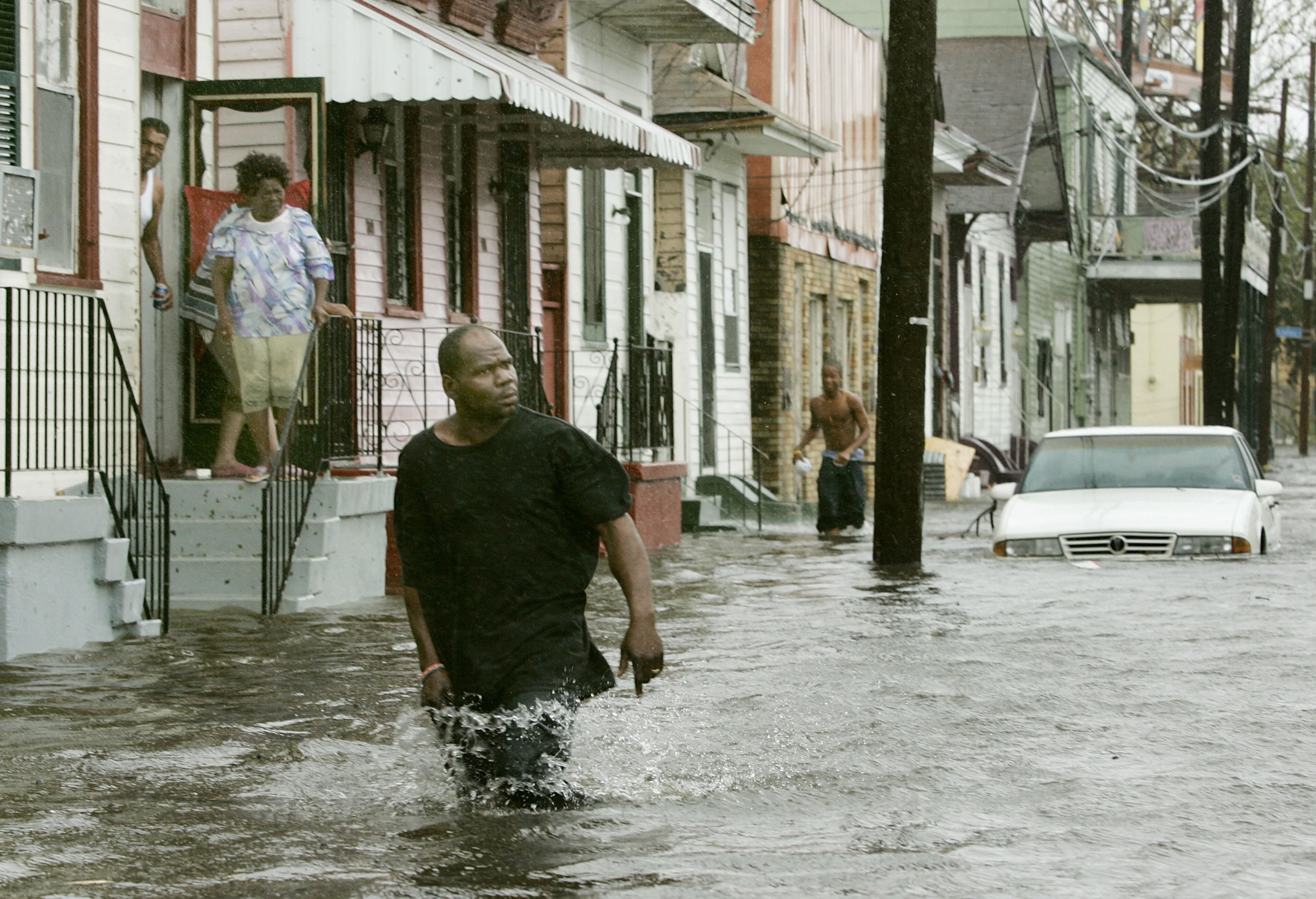 People come out of their homes to a flooded street after Hurricane Katrina hit the area with heavy wind and rain August 29, 2005 in New Orleans, Louisiana. Katrina was down graded to a category 4 storm as it approached New Orleans. (Photo by Mark Wilson/Getty Images)