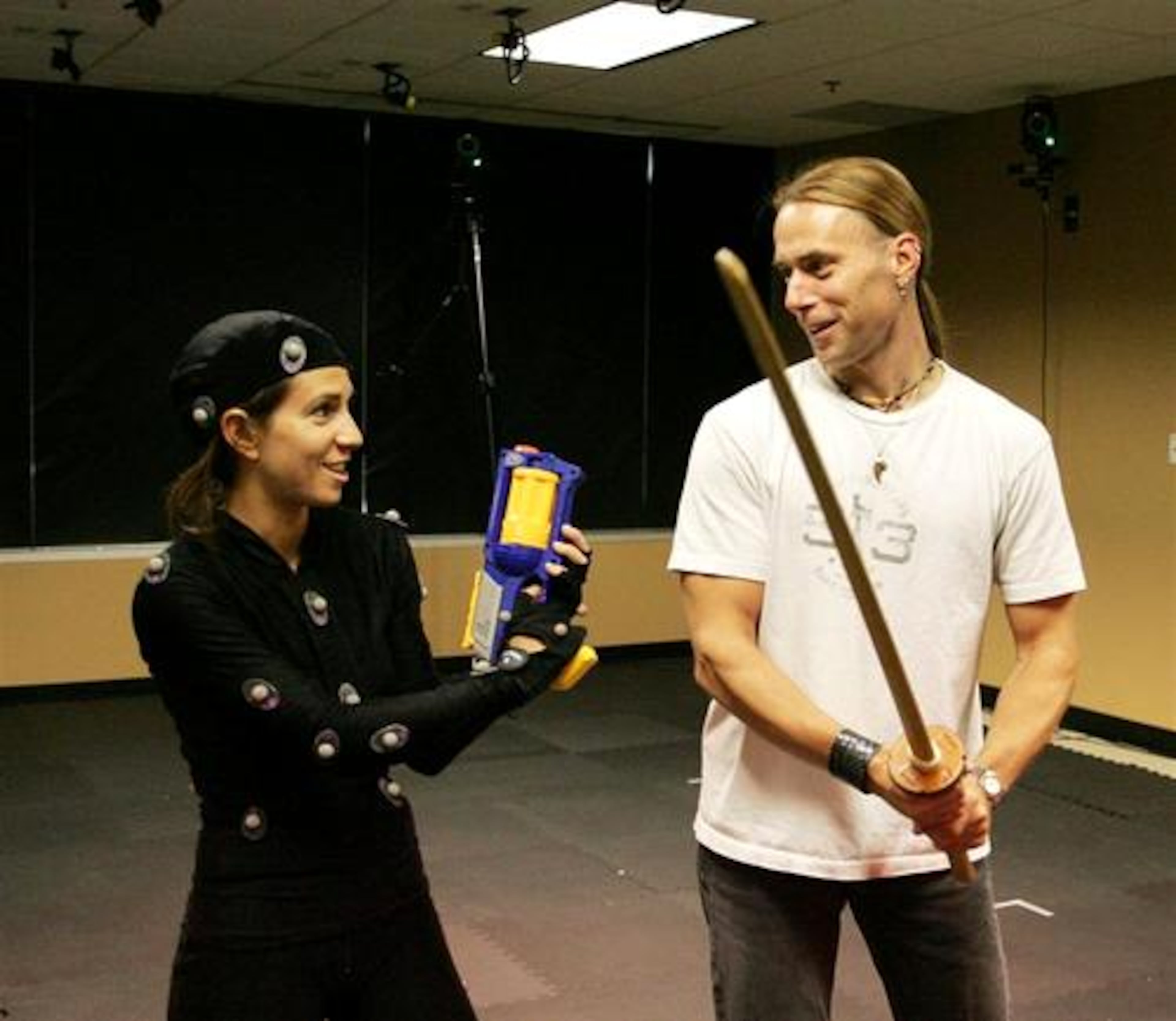Daniel Lilleberg(right)works with Michal Adam during a motion capture session at Hi-Rez Studios in Alpharetta. Adam dressed in a costume with "markers" on it for video used in computer animation. Multiple cameras around the room capture the "markers" on Adam to create a three dimensional image.