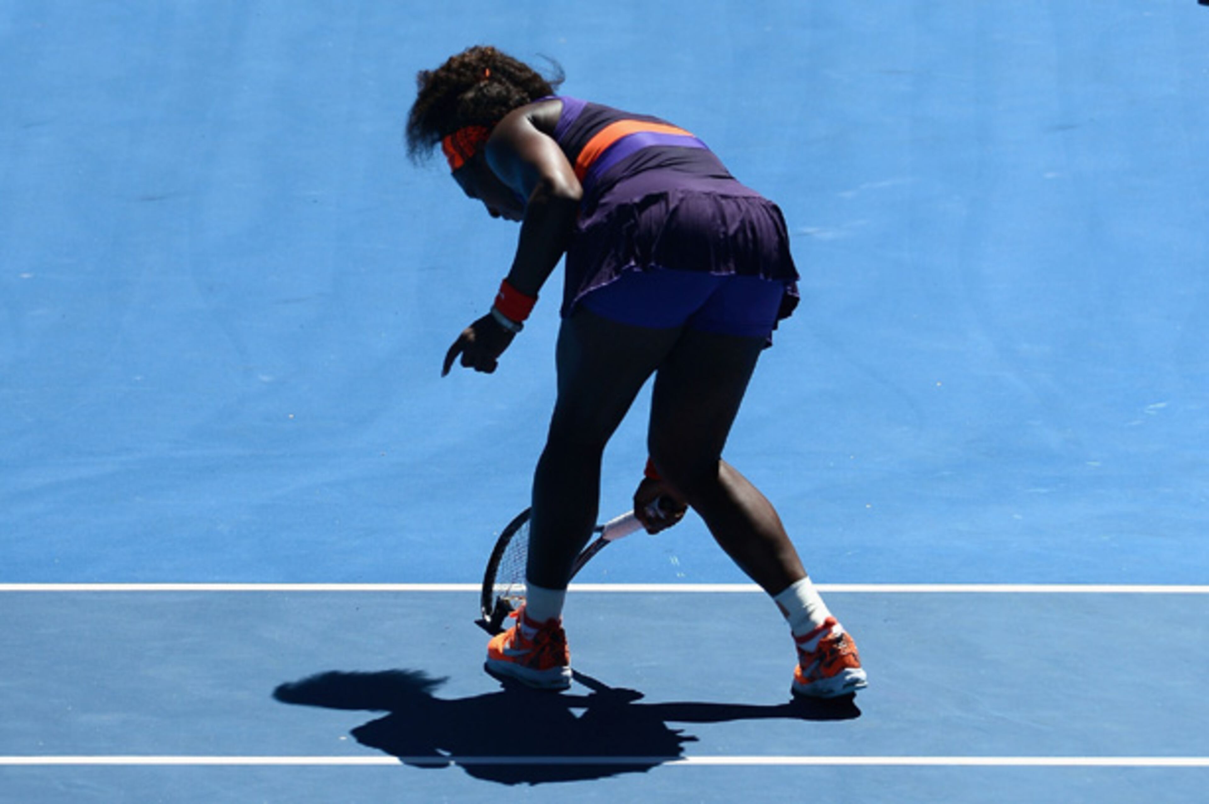 ... brought it down on the blue Melbourne court with such force it snapped the racket in two ...