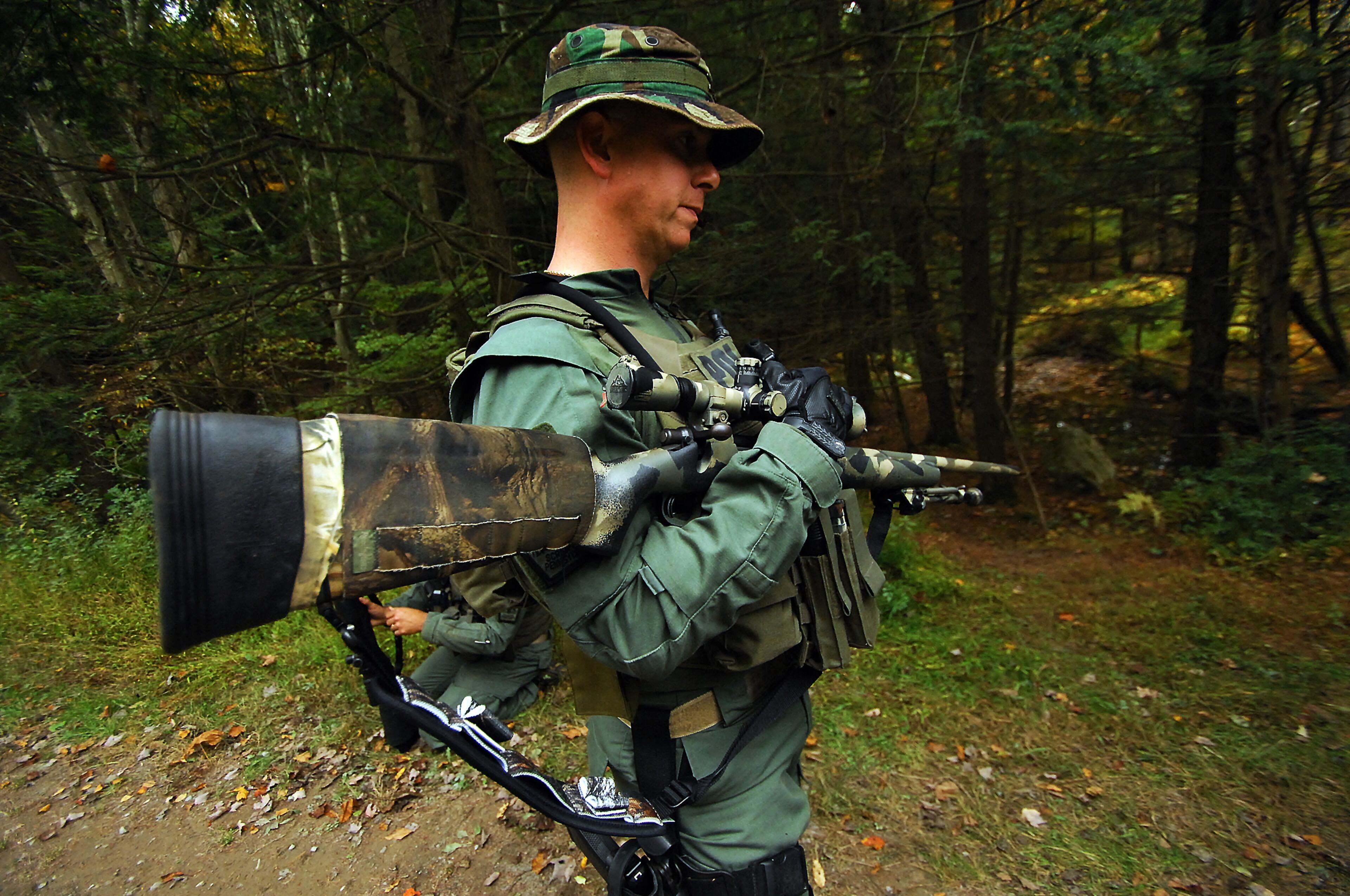 A member of the Scranton, Pa., Police Special Operations Group, prepares the woods, Thursday, Oct. 2, 2014, in Barrett Township near Canadensis, Pa., to search for suspected killer Eric Frein. A massive manhunt has been underway for 31-year-old Frein in the rugged terrain of the Pocono Mountains since Sept. 12. The self-taught survivalist is charged with killing Cpl. Bryon Dickson and seriously wounding Trooper Alex Douglass outside their barracks in Blooming Grove. (AP Photo/Scranton Times & Tribune, Butch Comegys) WILKES BARRE TIMES-LEADER OUT; MANDATORY CREDIT