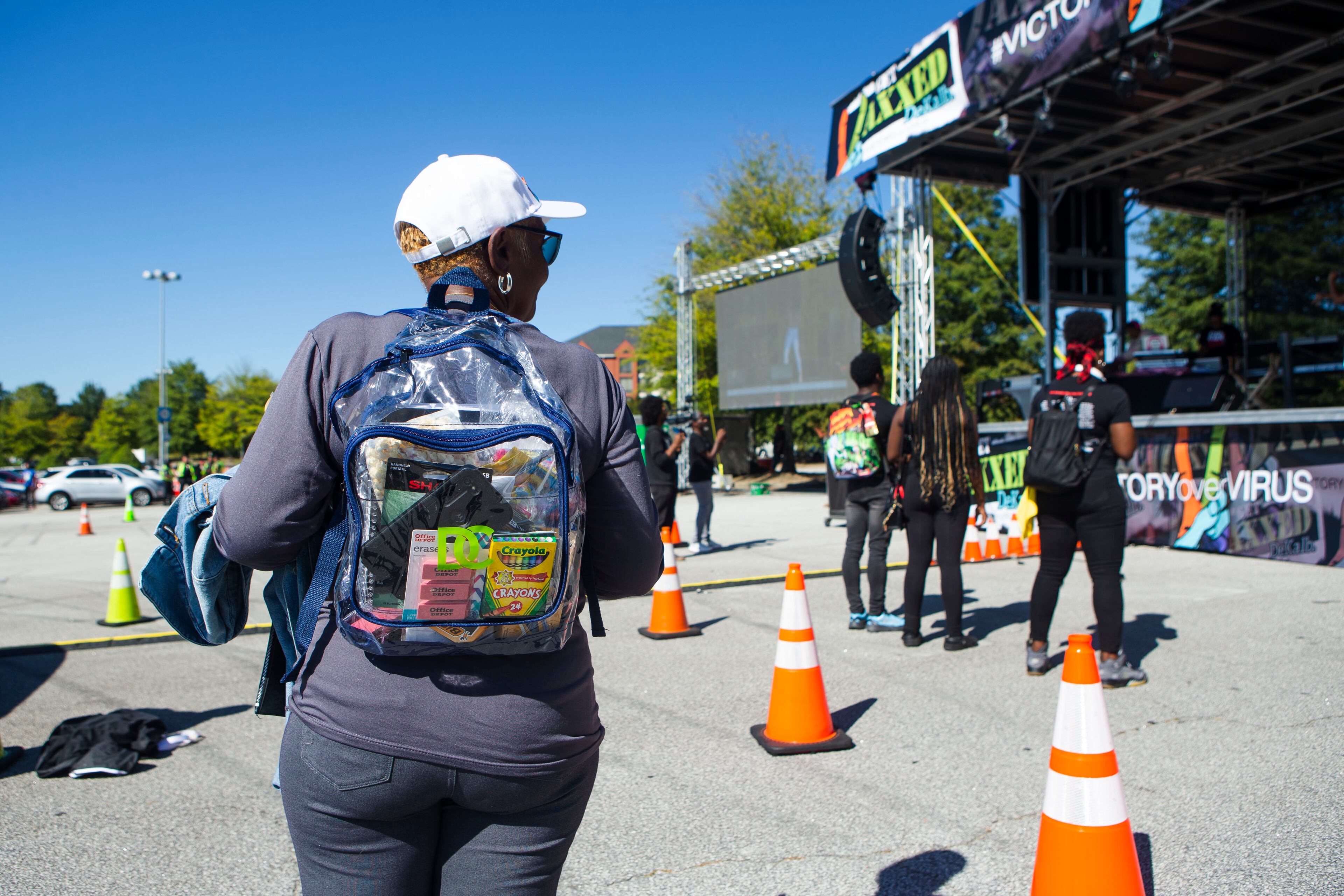 Cynthia Golden shows a backpack during the DeKalb County COVID-19 vaccination event on Saturday, September 24, 2022, at the Mall at Stonecrest. The event offered $100 gift cards, clear clear bookbags with school supplies for kids, and a lineup of performers for entertainment while people waited for their shots. CHRISTINA MATACOTTA FOR THE ATLANTA JOURNAL-CONSTITUTION
