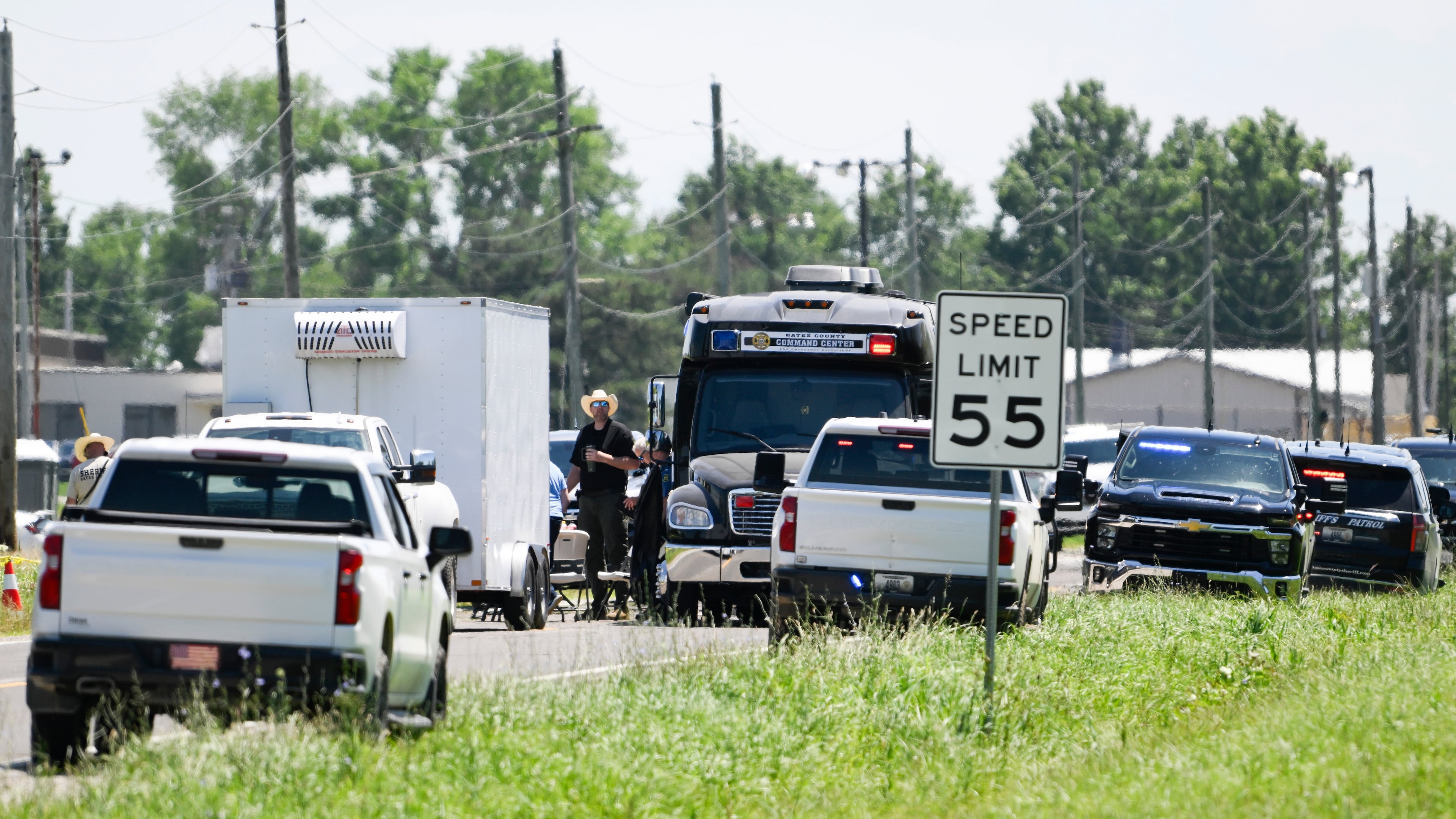 Emergency vehicles parked outside the Butler Memorial Airport after a plane crash in Butler, Mo., Sunday, June 14, 2026. (AP Photo/Reed Hoffmann)