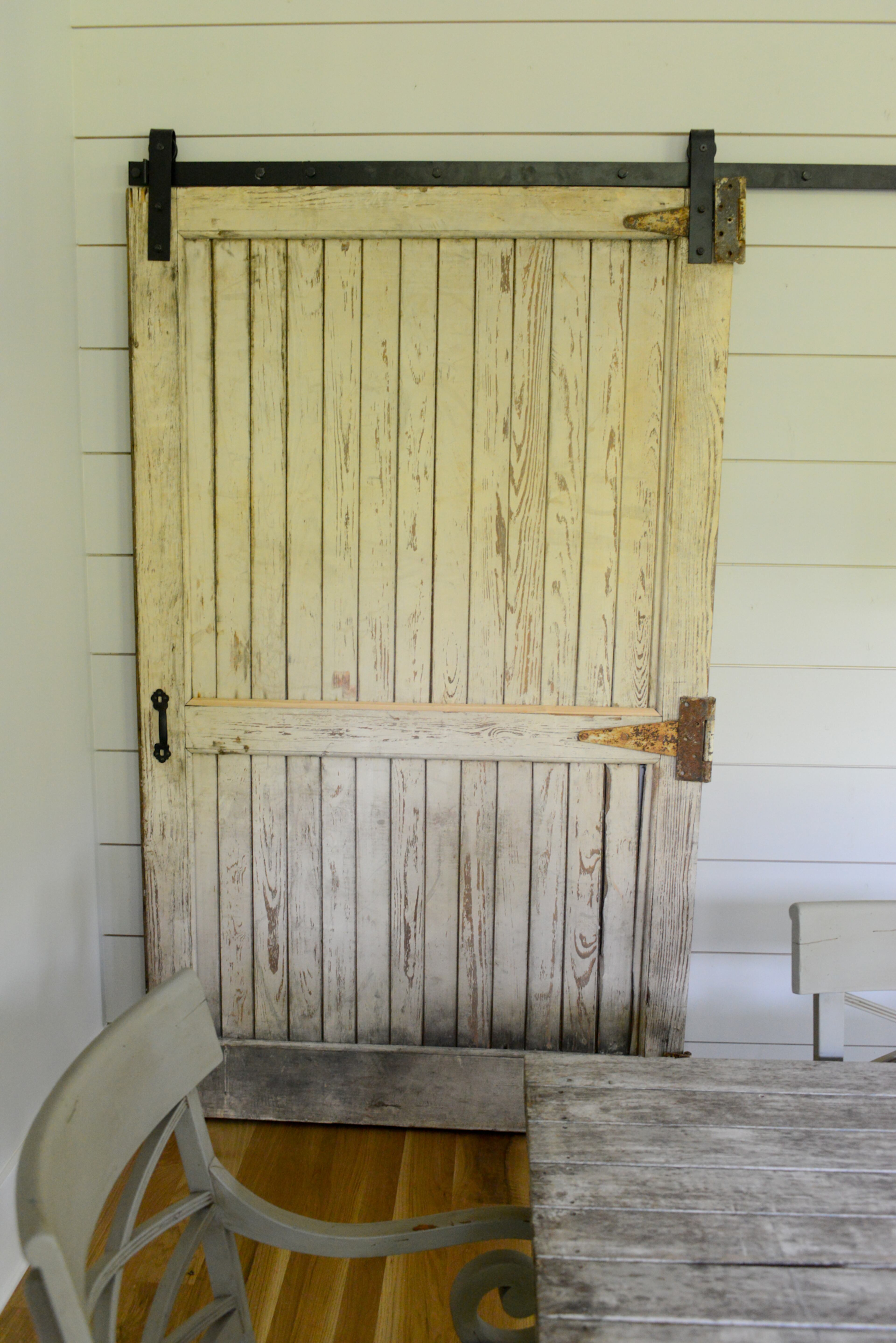 One of Nadine Bratti's favorite features in her home is the pantry's sliding barn door, found by Julie McKinney of McKinney & Son Builders. "She has an incredible style," says Bratti. "She was so helpful in understanding my style and being able to pull in softer textures."