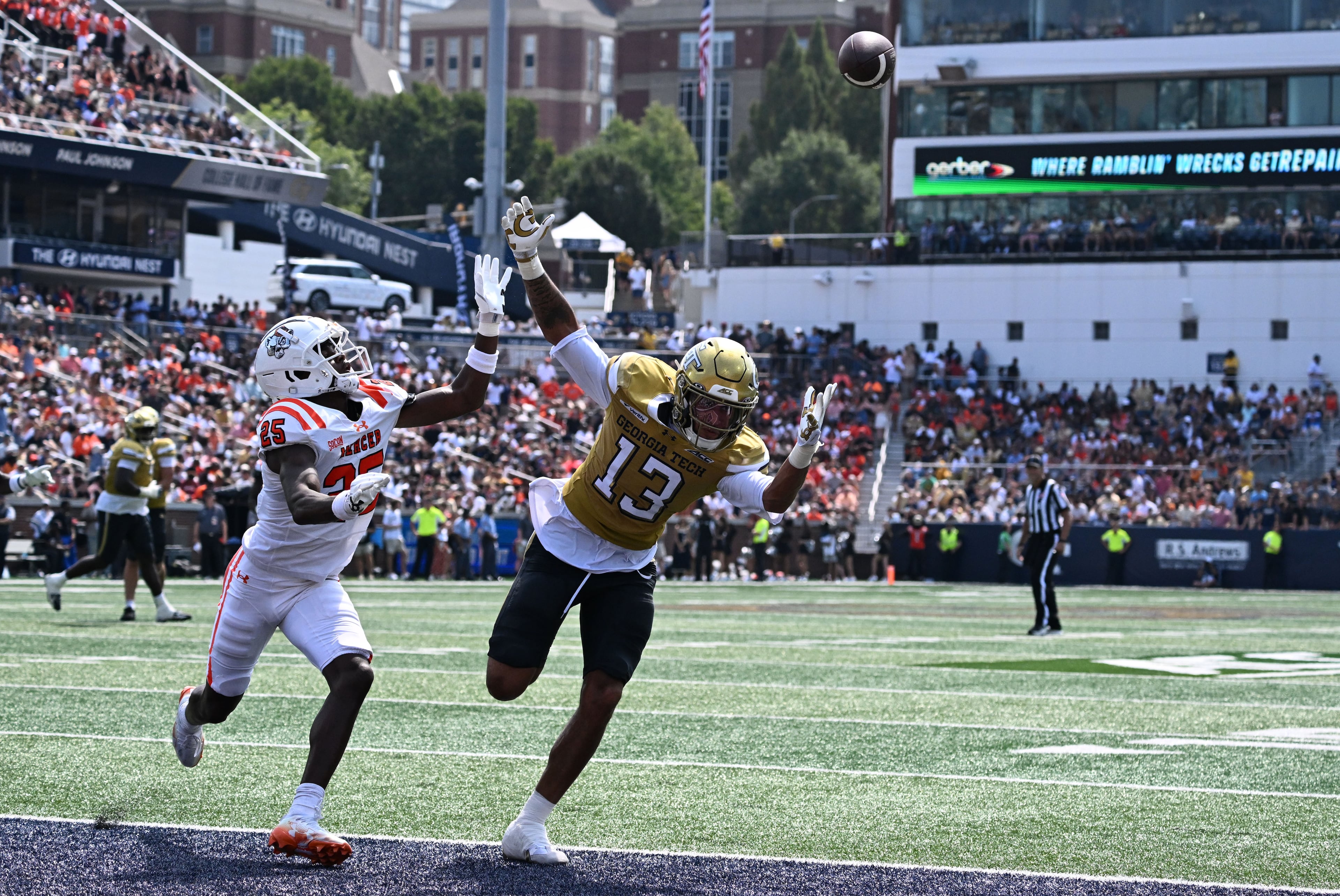 Georgia Tech wide receiver Isaiah Fuhrmann (13) is not able to catch under pressure from Mercer linebacker Evin McDowell (25) during the first half in an NCAA college football game at Bobby Dodd Stadium on Saturday, Sept. 19, 2026, in Atlanta. (Hyosub Shin/AJC)