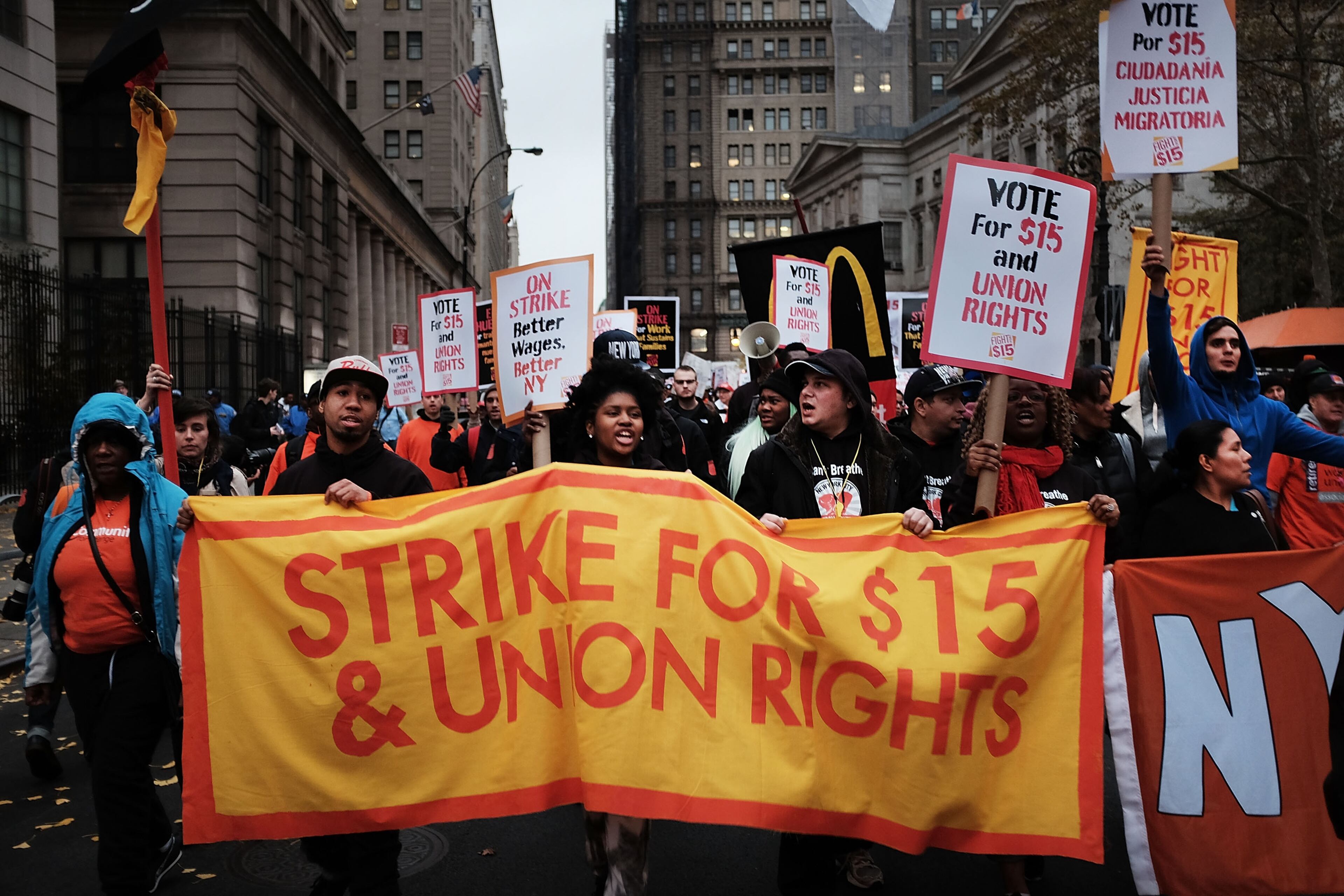 NEW YORK, NY - NOVEMBER 10: Low wage workers and supporters protest for a $15 an hour minimum wage on November 10, 2015 in New York, United States. In what organizers are calling a National Day of Action for $15 and hour minimum wage, thousands of people took to the streets across the country to stage protests in front of businesses that are paying some of their workers the minimum wage. Home care workers, employees in retail and fast food restaurants say that the current minimum is not a living wage. (Photo by Spencer Platt/Getty Images)