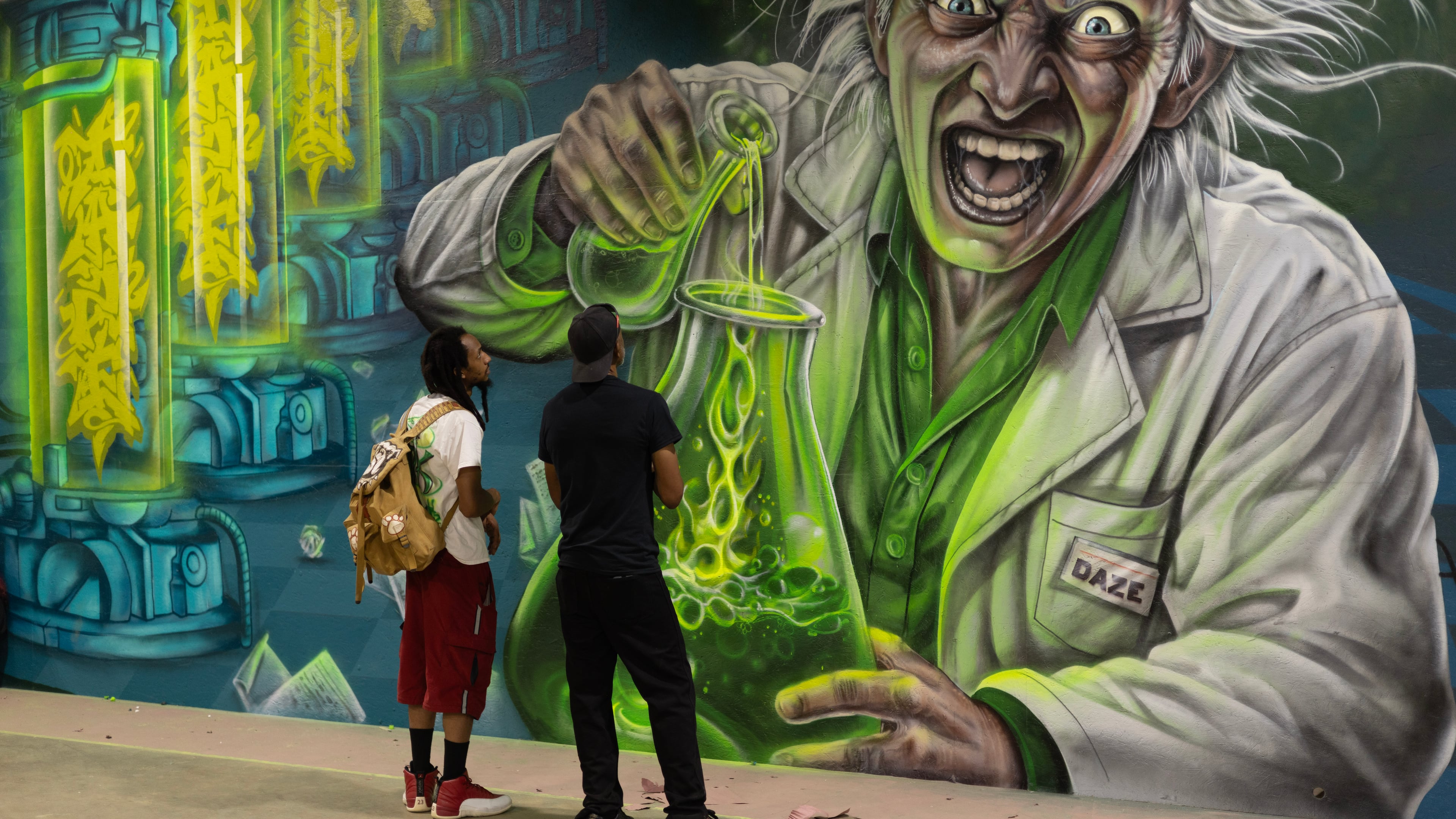 Guests at the August grand opening of the Foundry — a manufacturing warehouse converted into an artist studio campus in Southwest Atlanta — get a close-up view of new wall art. (Courtesy of Thomas Forman)