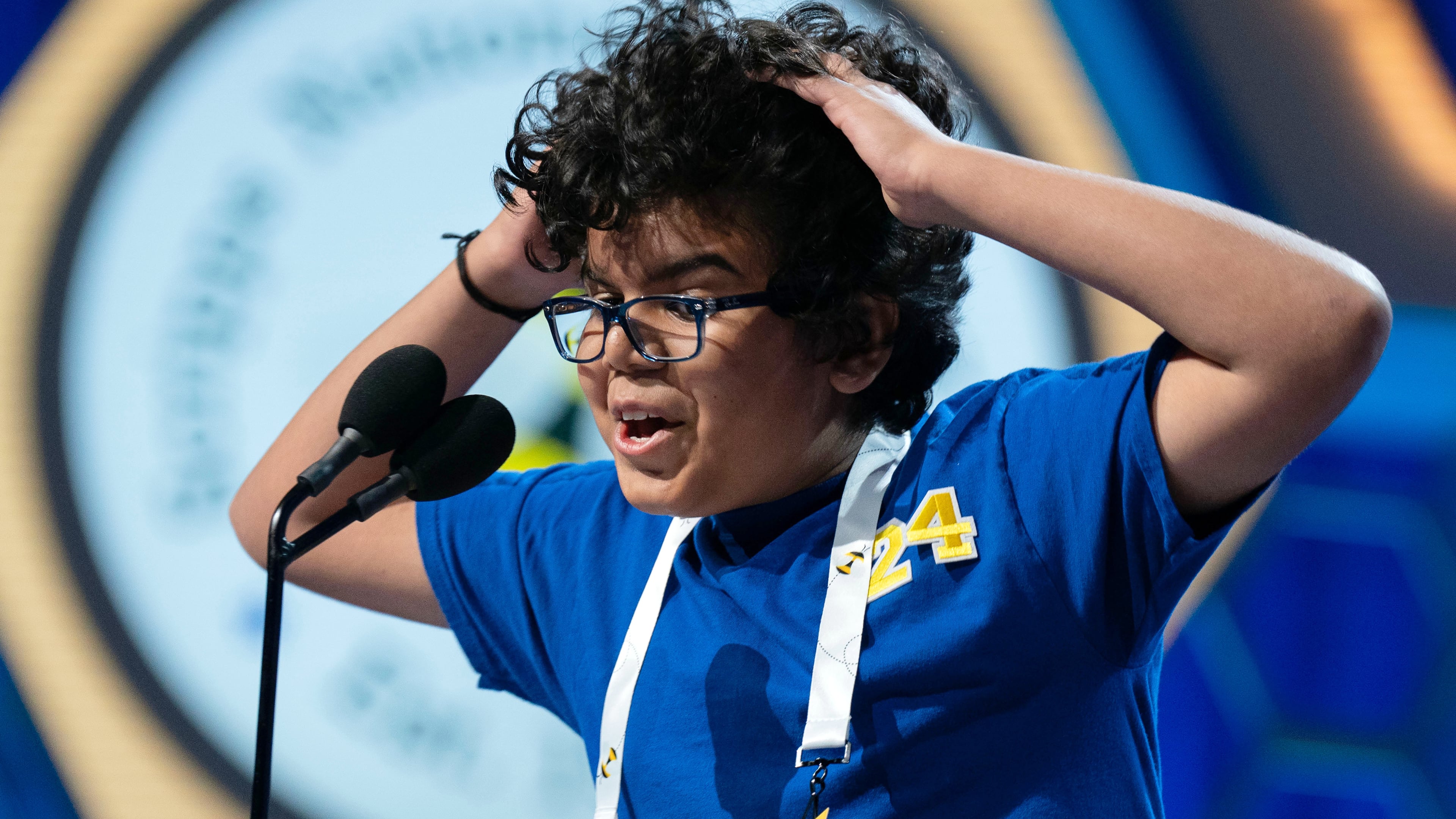 Thivaan Butani, 12, of Austin, Texas reacts after spelling correctly his word during the semifinals of the Scripps National Spelling Bee at DAR Constitution Hall, Wednesday, May 27, 2026, in Washington. (AP Photo/Jose Luis Magana)