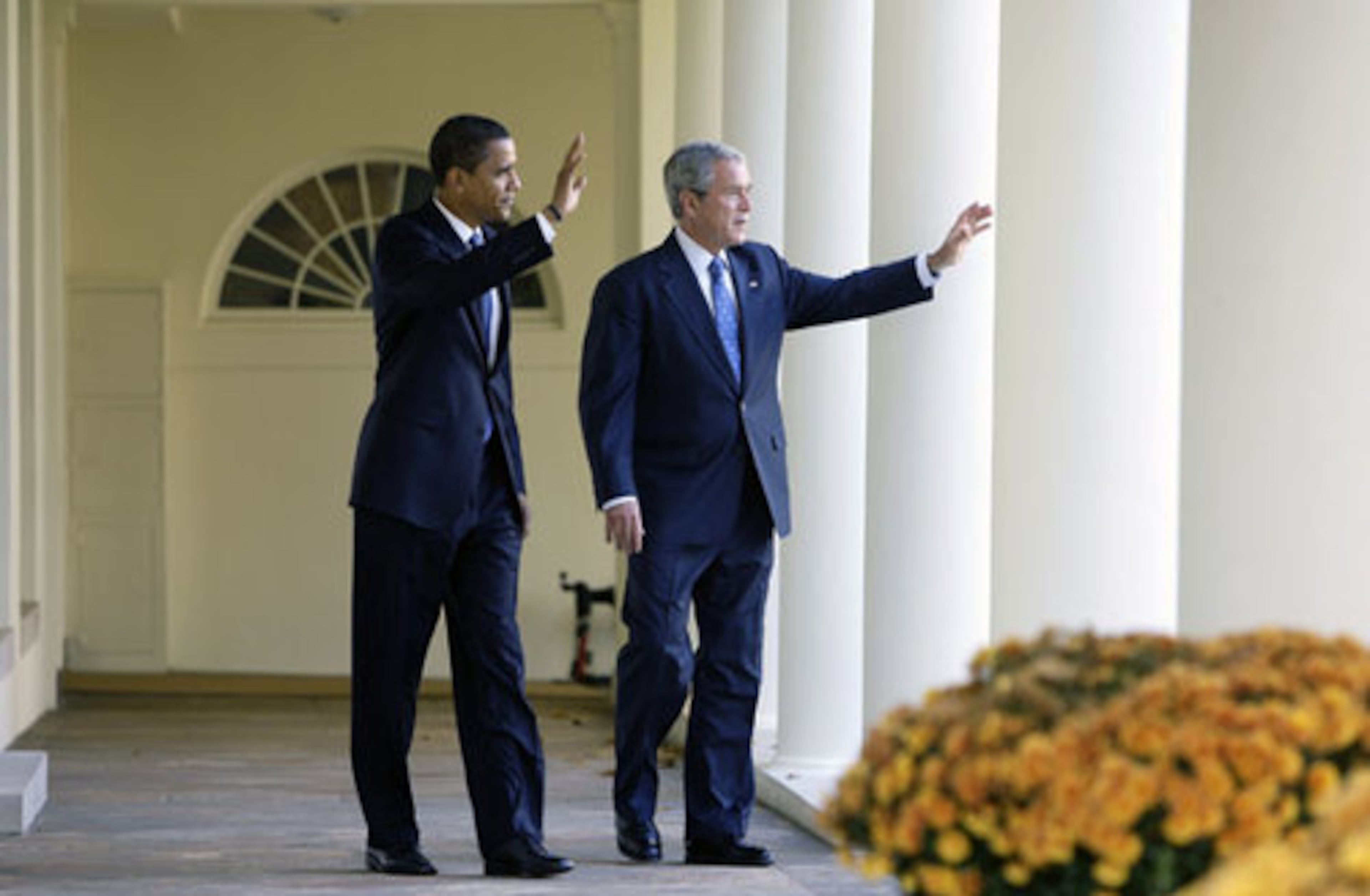 President-elect Barack Obama and President George W. Bush wave to well-wishers at the White House.