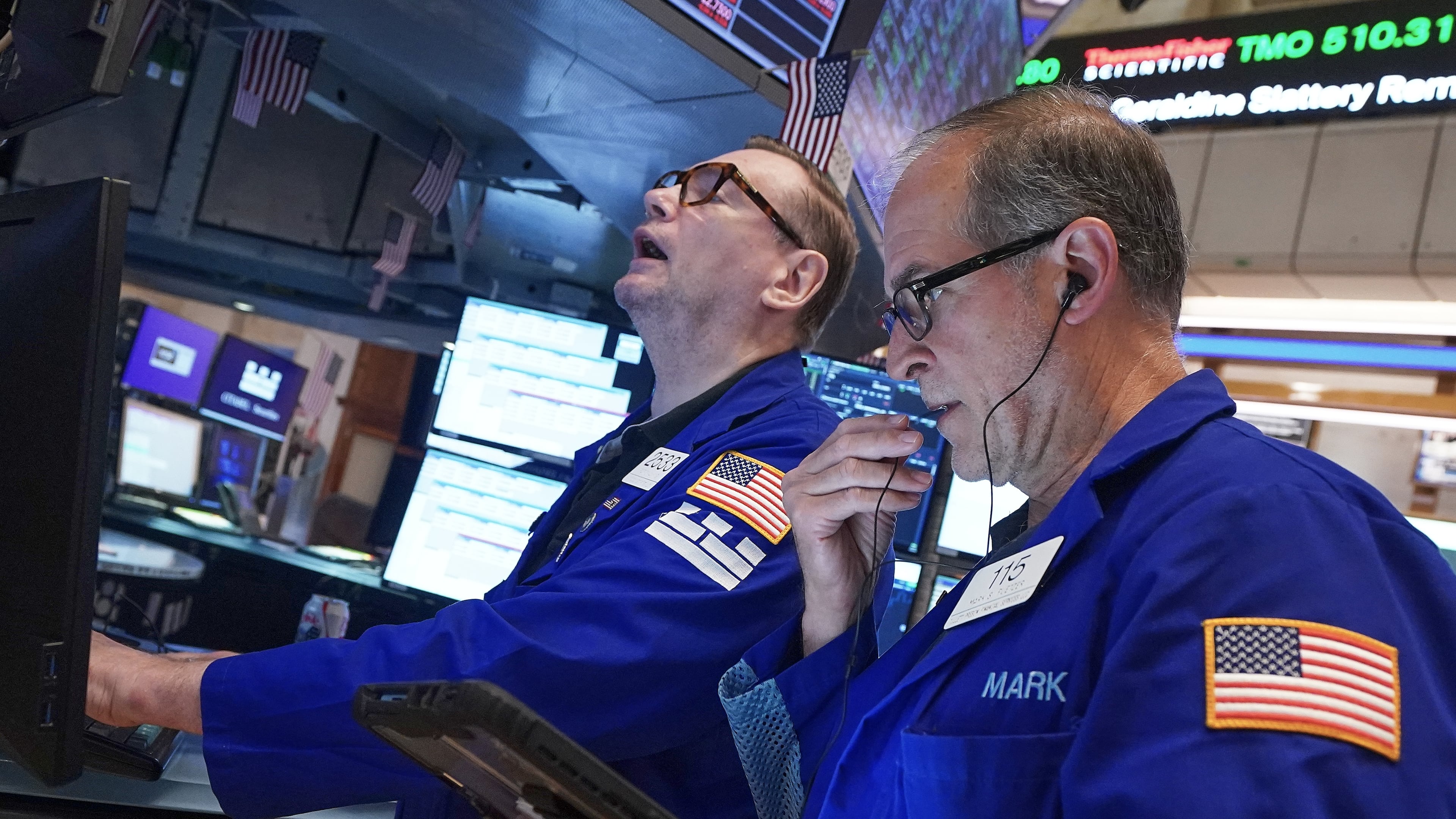 Specialist Patrick King, left, and trader Mark Puetzer work on the floor of the New York Stock Exchange, Friday, June 26, 2026. (AP Photo/Richard Drew)
