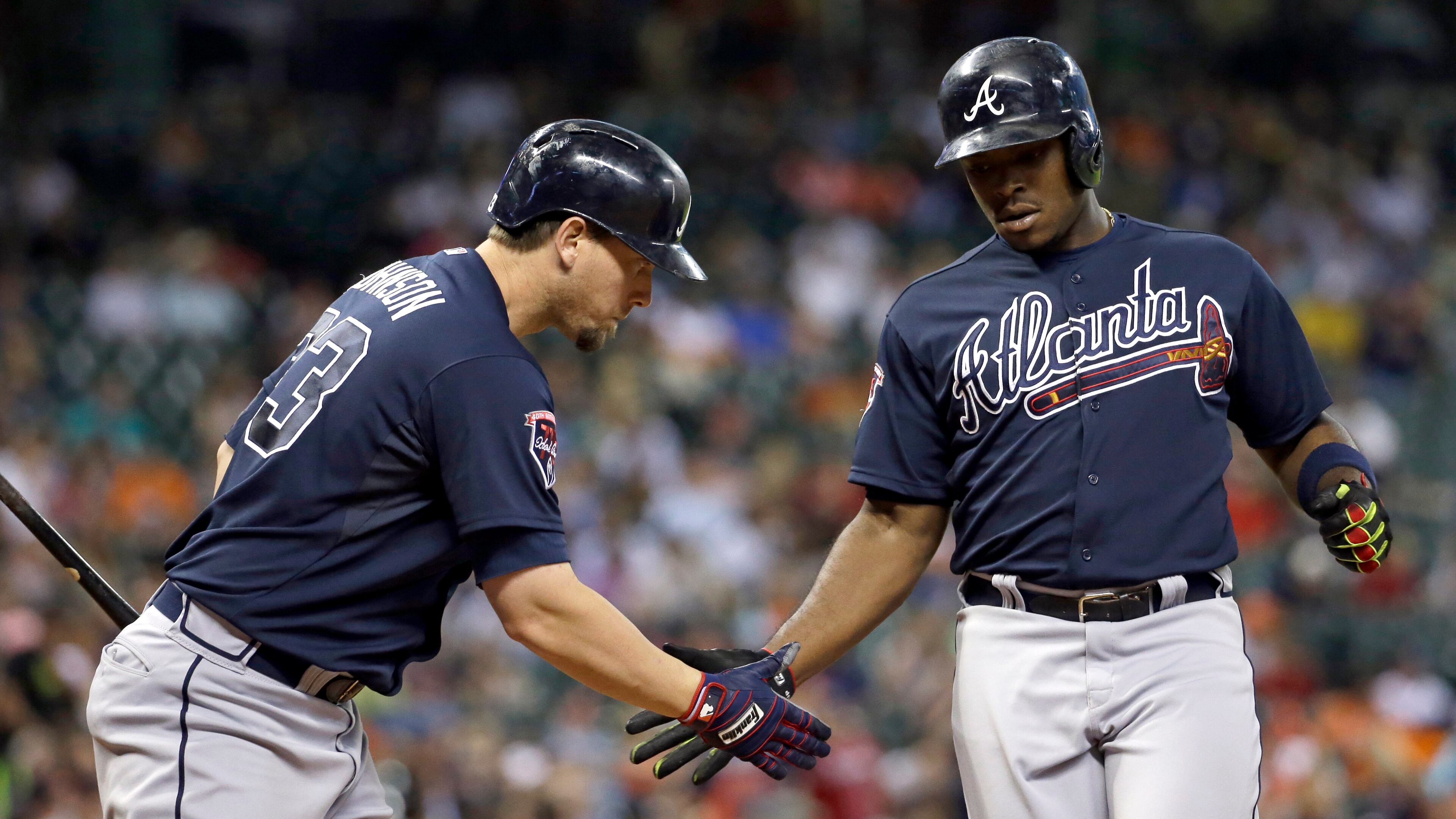 Atlanta Braves' Justin Upton, right, is congratulated by Chris Johnson after hitting a home run against the Houston Astros during the fourth inning of a baseball game Tuesday, June 24, 2014, in Houston. (AP Photo/David J. Phillip)