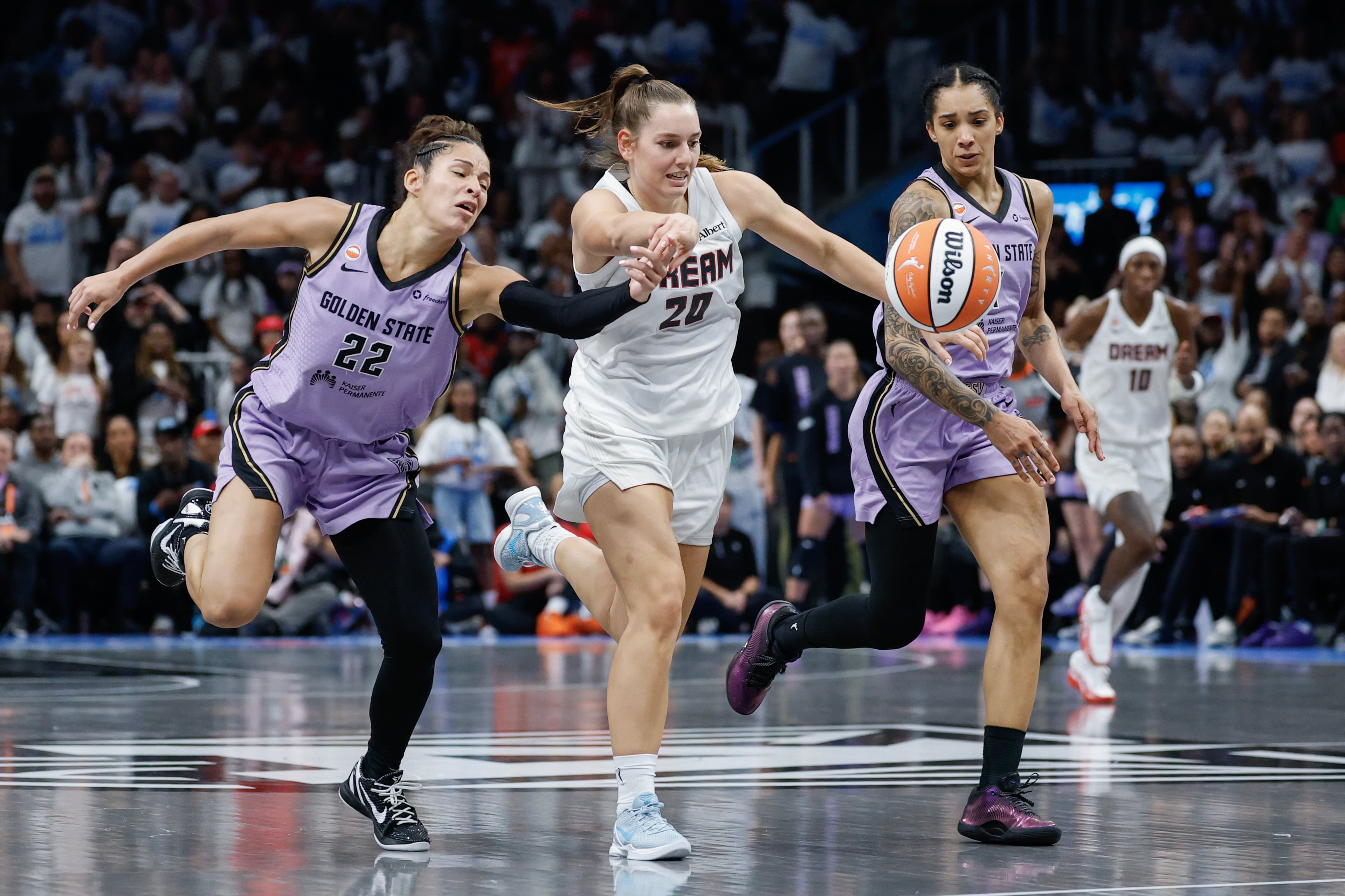 Atlanta Dream guard Isobel Borlase (center) is defended by Golden State Valkyries guard Veronica Burton (left) and forward Gabby Williams (right) during the second half of Game 4 of the WNBA Finals between the Atlanta Dream and the Golden State Valkyries, Saturday, Oct. 24, 2026, in Atlanta. (Erik S. Lesser for the AJC)