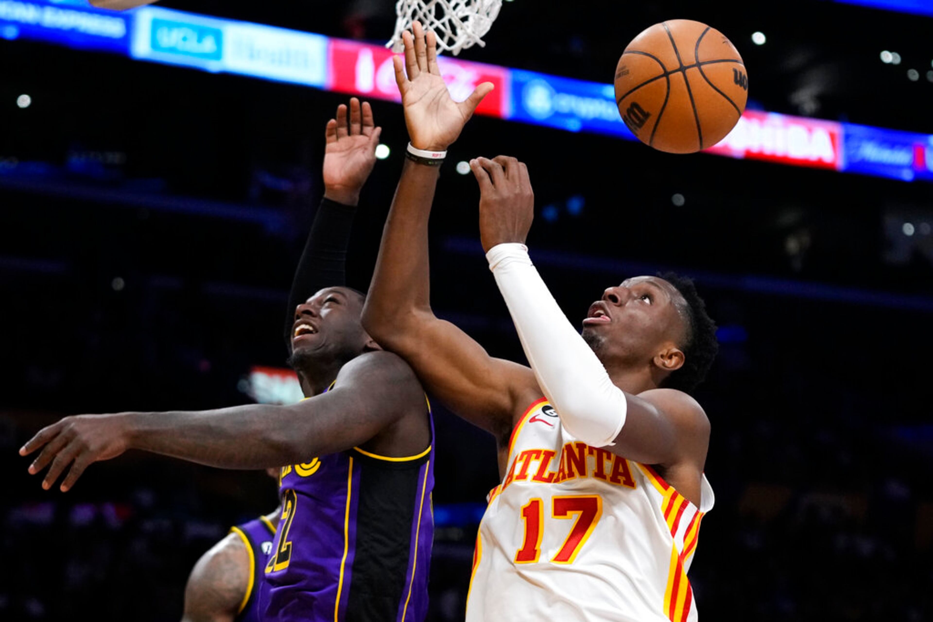 Atlanta Hawks' Onyeka Okongwu (17) looks to grab a rebound against Los Angeles Lakers' Kendrick Nunn (12) during the second half of an NBA basketball game Friday, Jan. 6, 2023, in Los Angeles. The Lakers won 130-114. (AP Photo/Jae C. Hong)