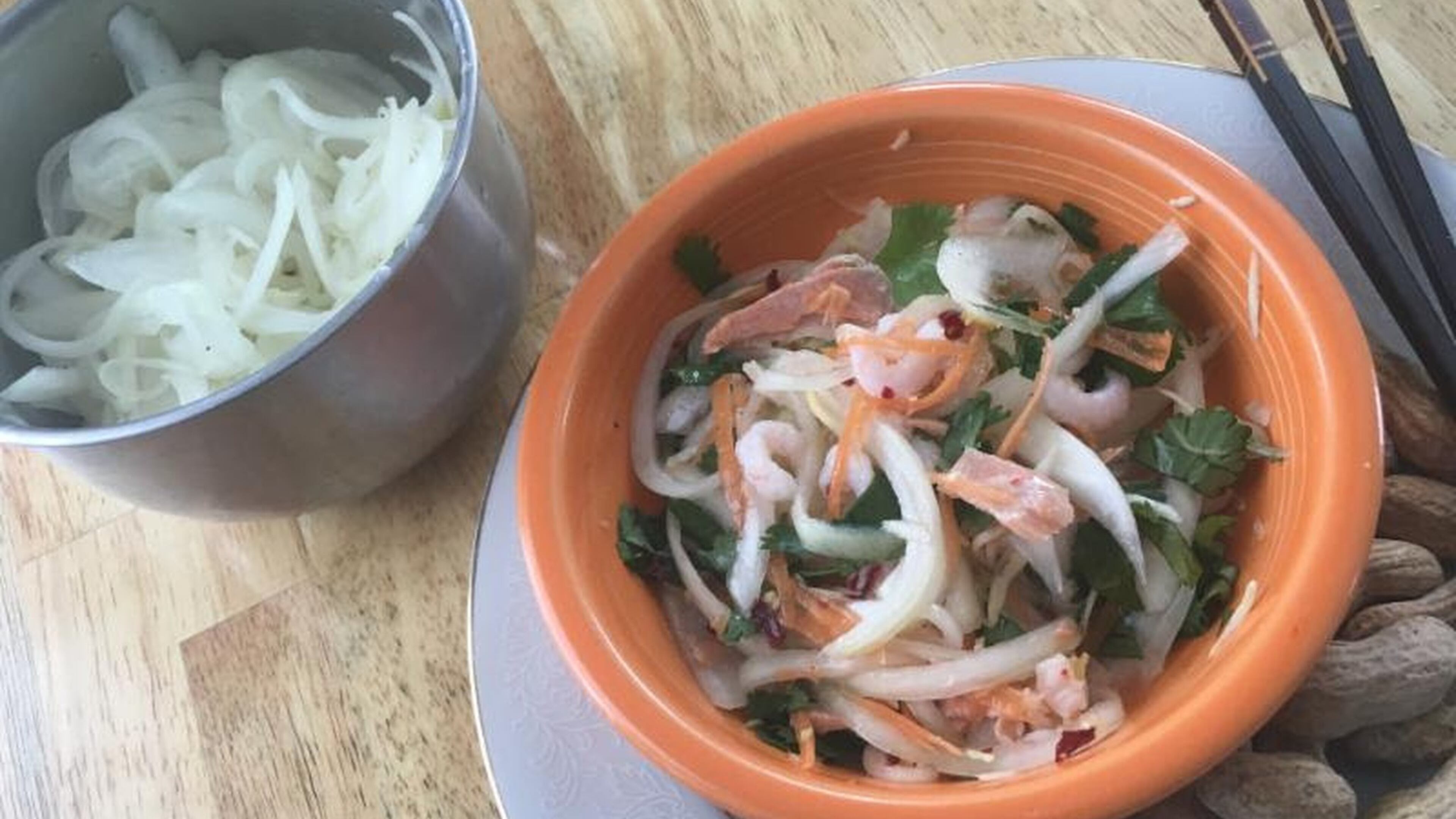 “Onion salad with grated carrot, cabbage, ginger and celeriac, and shrimp, salmon, crushed chili flakes and fresh cilantro.” Photo by Ari LeVaux.