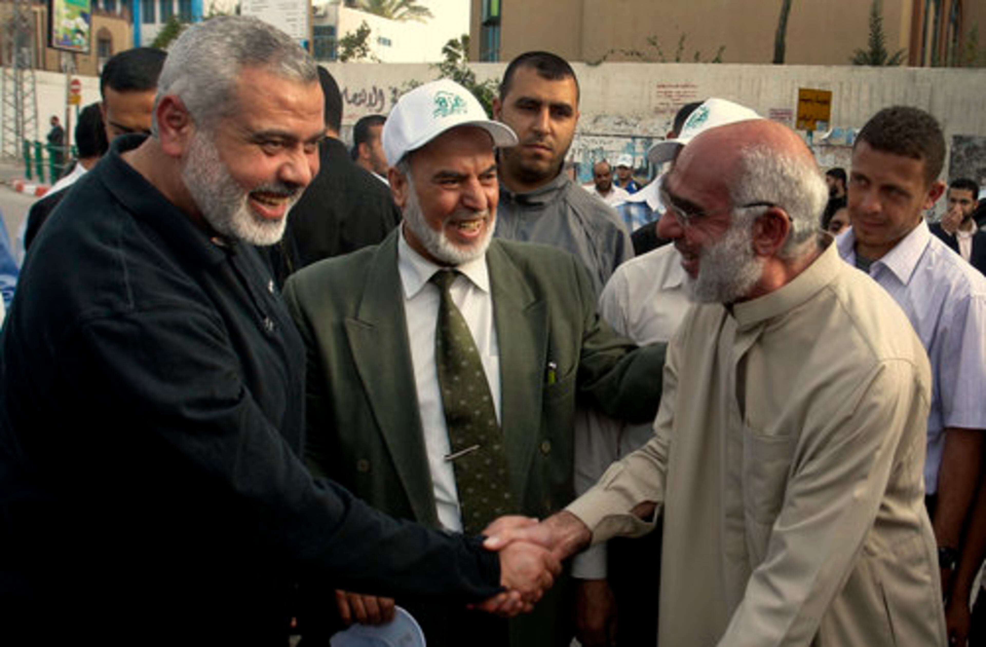 Gaza's Hamas Prime Minister Ismail Haniyeh, left, takes part in a tree planting ceremony during May Day celebrations in Gaza City, Monday, May 2, 2011. Haniyeh condemned the United States on Monday for killing al-Qaida chief Osama bin Laden, saying the operation marked "the continuation of the American oppression and shedding of blood of Muslims and Arabs."