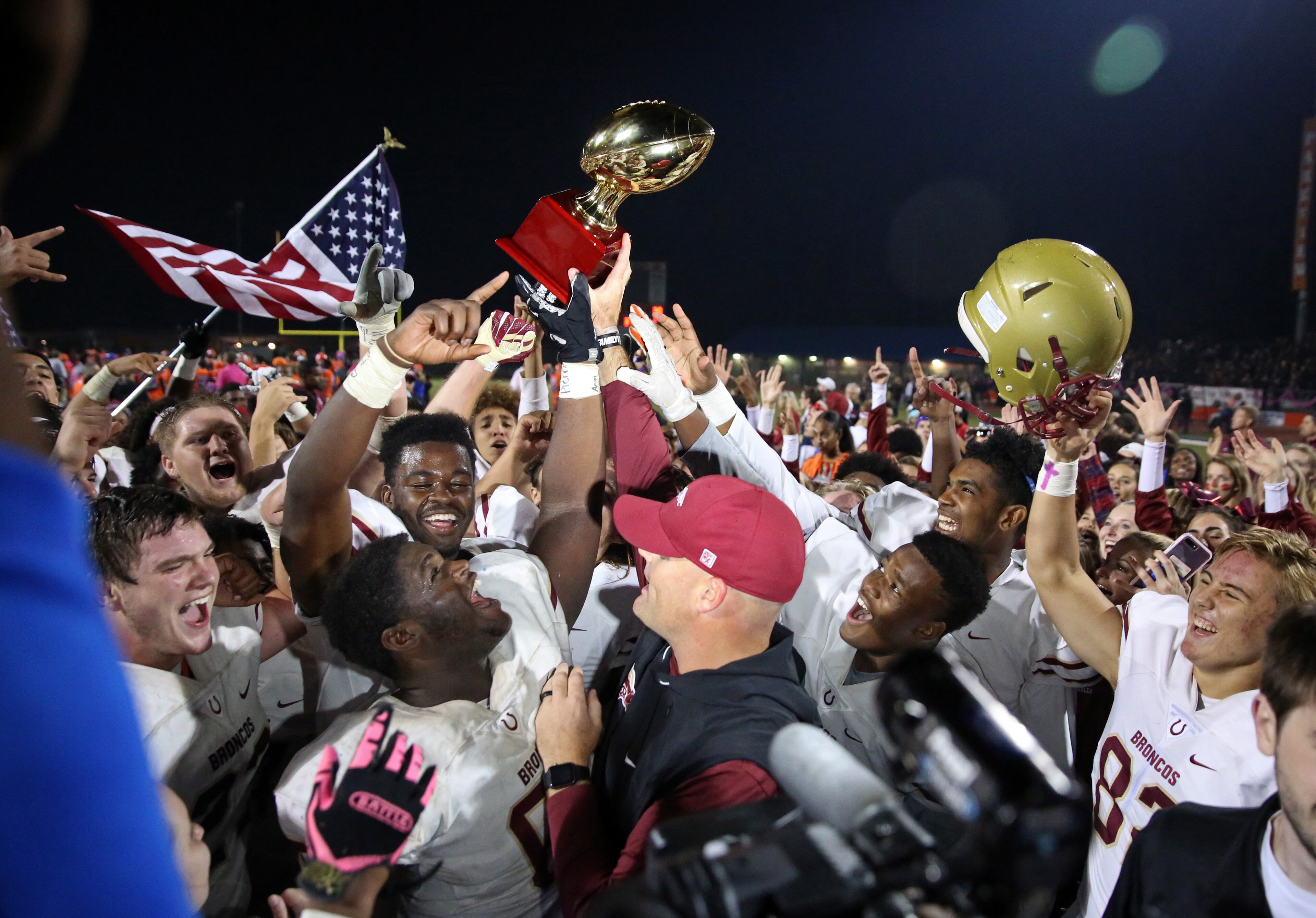 October 20, 2017 - Lilburn, Ga: Brookwood head coach Philip Jones receives a trophy as they celebrate their win against Parkview at Parkview High School Friday, October 20, 2017, in Lilburn, Ga.. Brookwood won 30-27. PHOTO / JASON GETZ