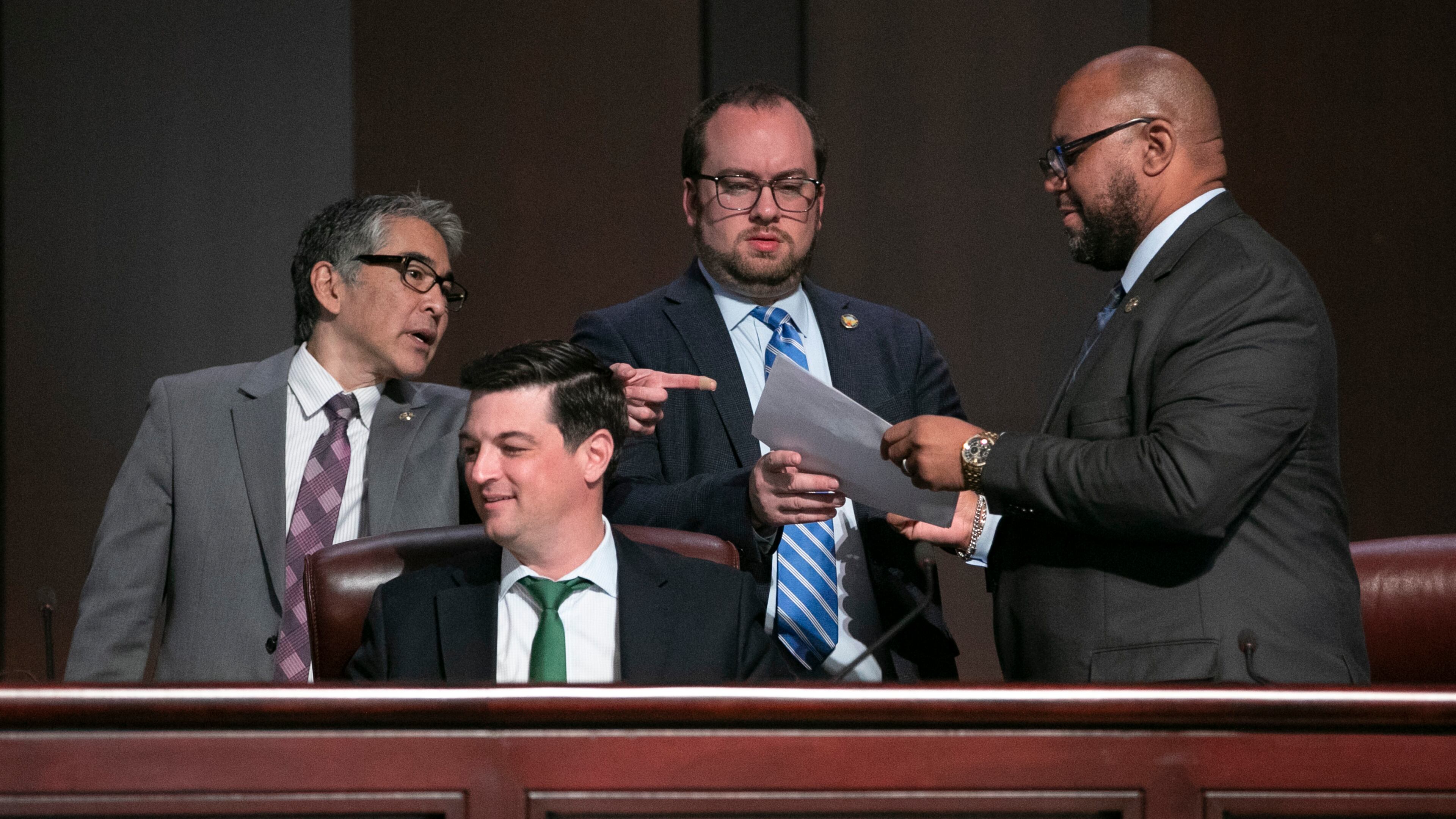 City Council members (from left), Alex Wan, Amir Farokhi , Dustin Hillis and Byron Amos confer as the Atlanta City Council held an in-person meeting on Monday, March 21, 2022. (Bob Andres / robert.andres@ajc.com)