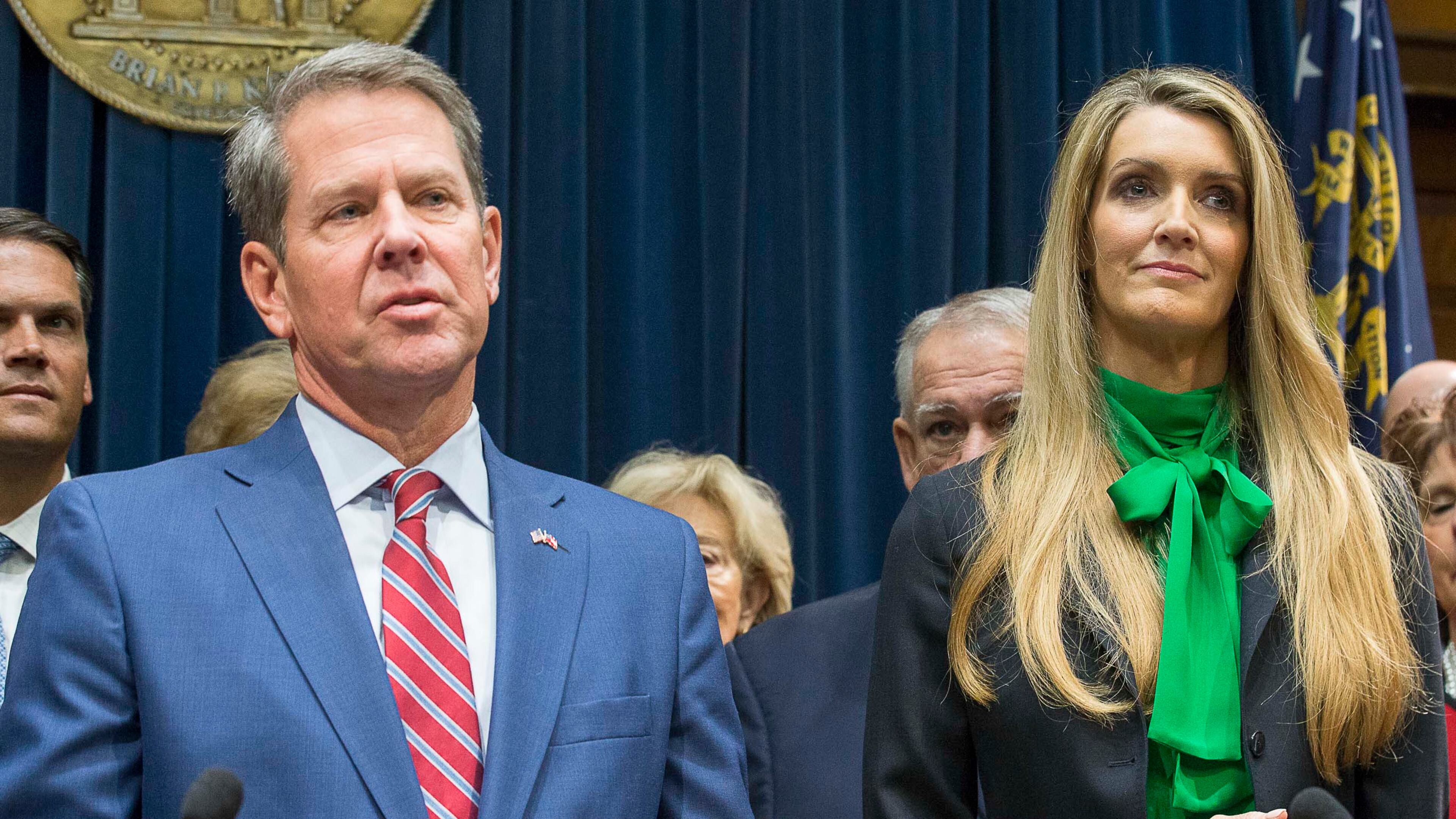 12/04/2019 -- Atlanta, Georgia -- Newly appointed U.S. Senator Kelly Loeffler (right) listens as Georgia Gov. Brian Kemp (left) speaks during a press conference in his office at the Georgia State Capitol Building, Wednesday, December 4, 2019. Georgia Gov. Brian Kemp appointed Kelly Loeffler to the U.S. Senate to take the place of U.S. Senator Johnny Isakson, who is stepping down for health reasons. (ALYSSA POINTER/ALYSSA.POINTER@AJC.COM)