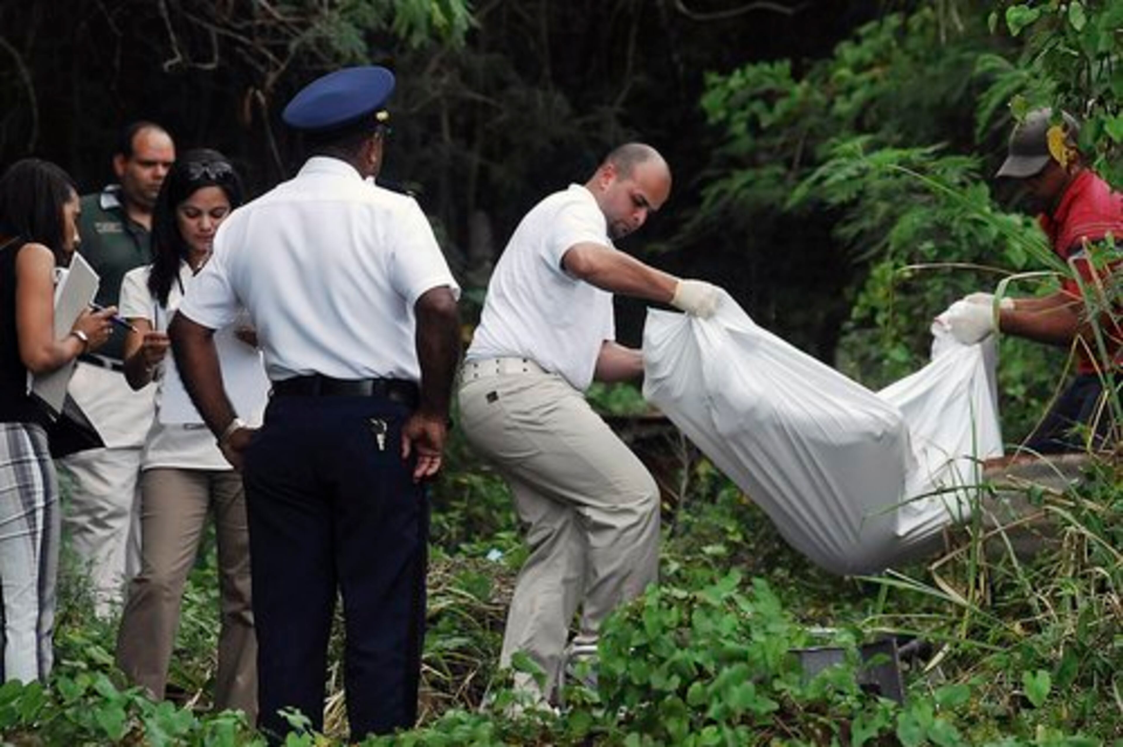 Forensic personnel remove the body of Kuszak.
