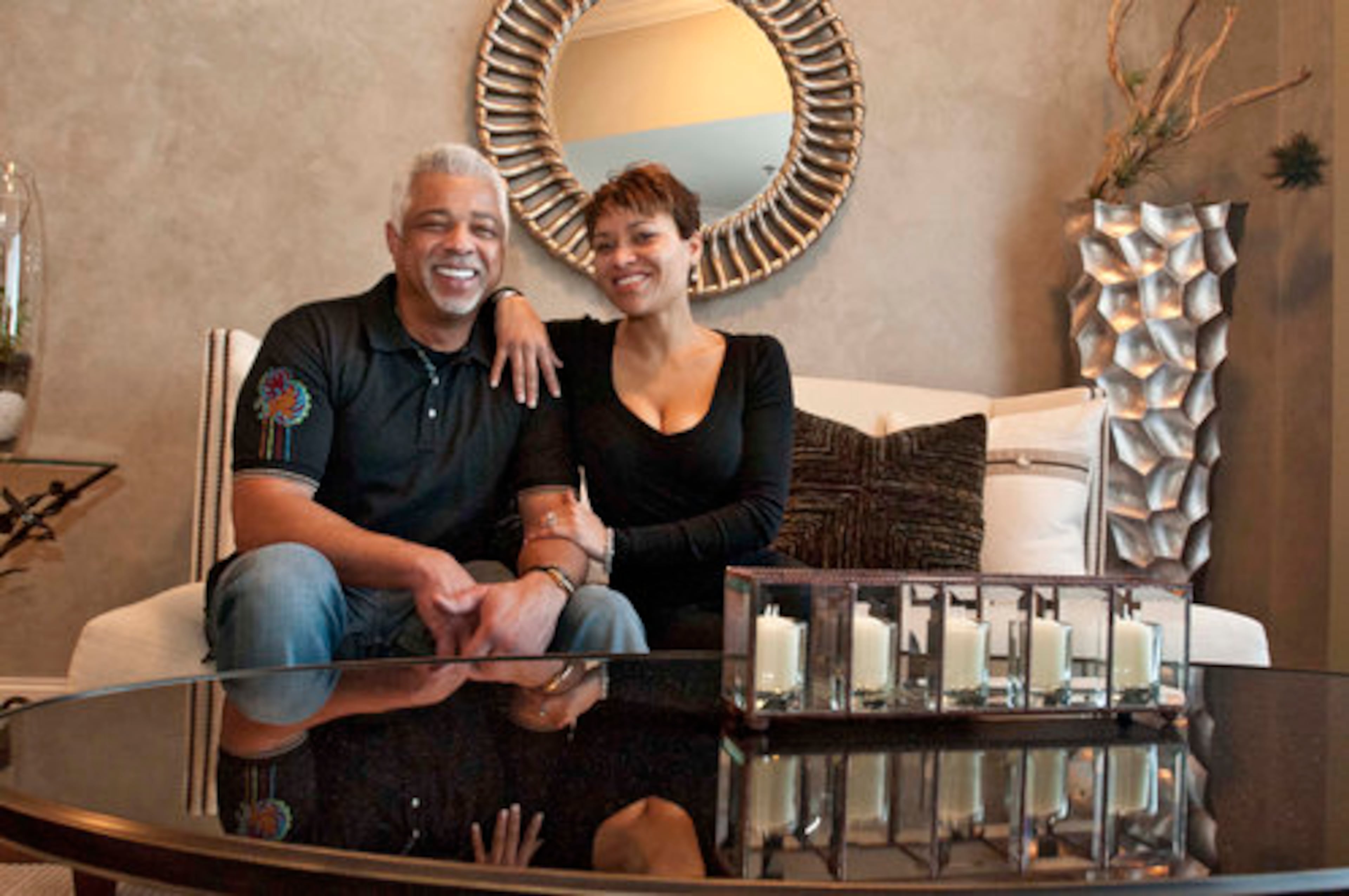 Tyrone Talifer and Donya Redmond relax in the living room of their condo at The Atlantic. The couple's daughter, Catherine Talifer, was visiting Atlanta in 2008 when she suggested her Midwestern parents take a trip to the South to check out Atlantic Station.