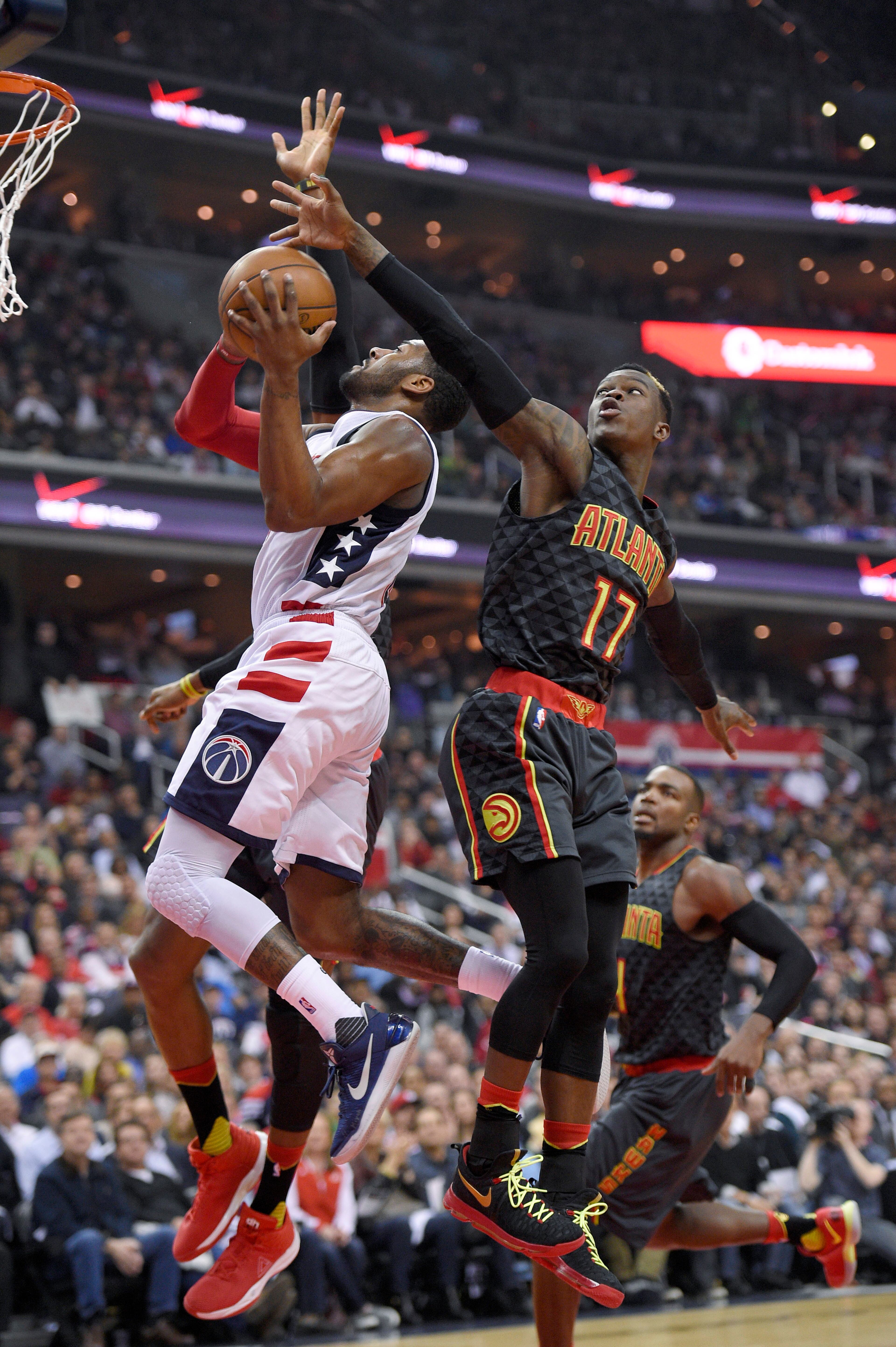 Washington Wizards guard John Wall, left,goes to the basket past Atlanta Hawks guard Dennis Schroeder (17), of Germany, during the first half in Game 2 of a first-round NBA basketball playoff series, Wednesday, April 19, 2017, in Washington. (AP Photo/Nick Wass)