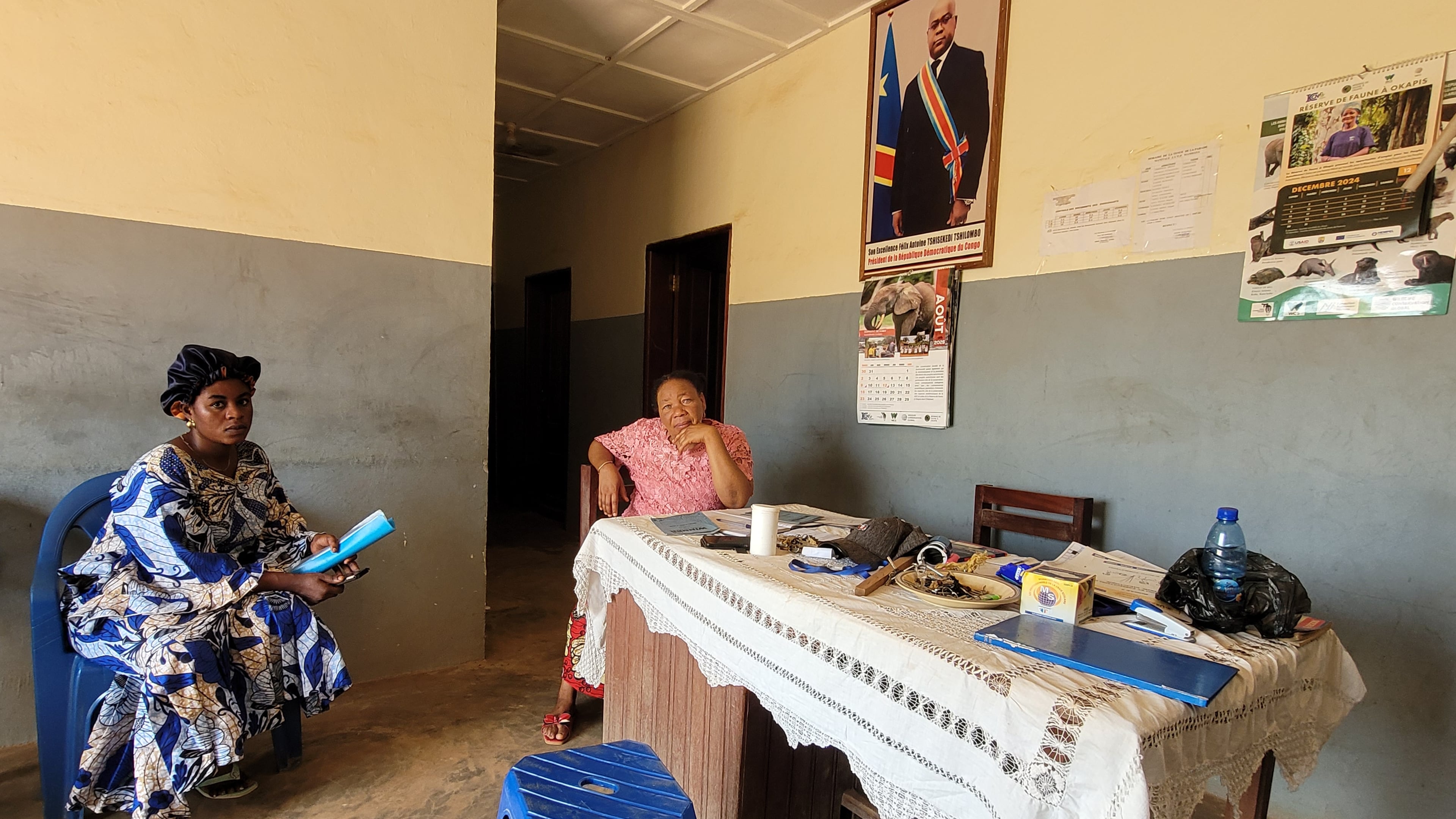 Parents who came for their children's school resumption sit inside an office of a school in Ituri province, eastern Congo, Thursday, Aug. 27, 2026. (AP Photo/Constant Same Bagalwa)