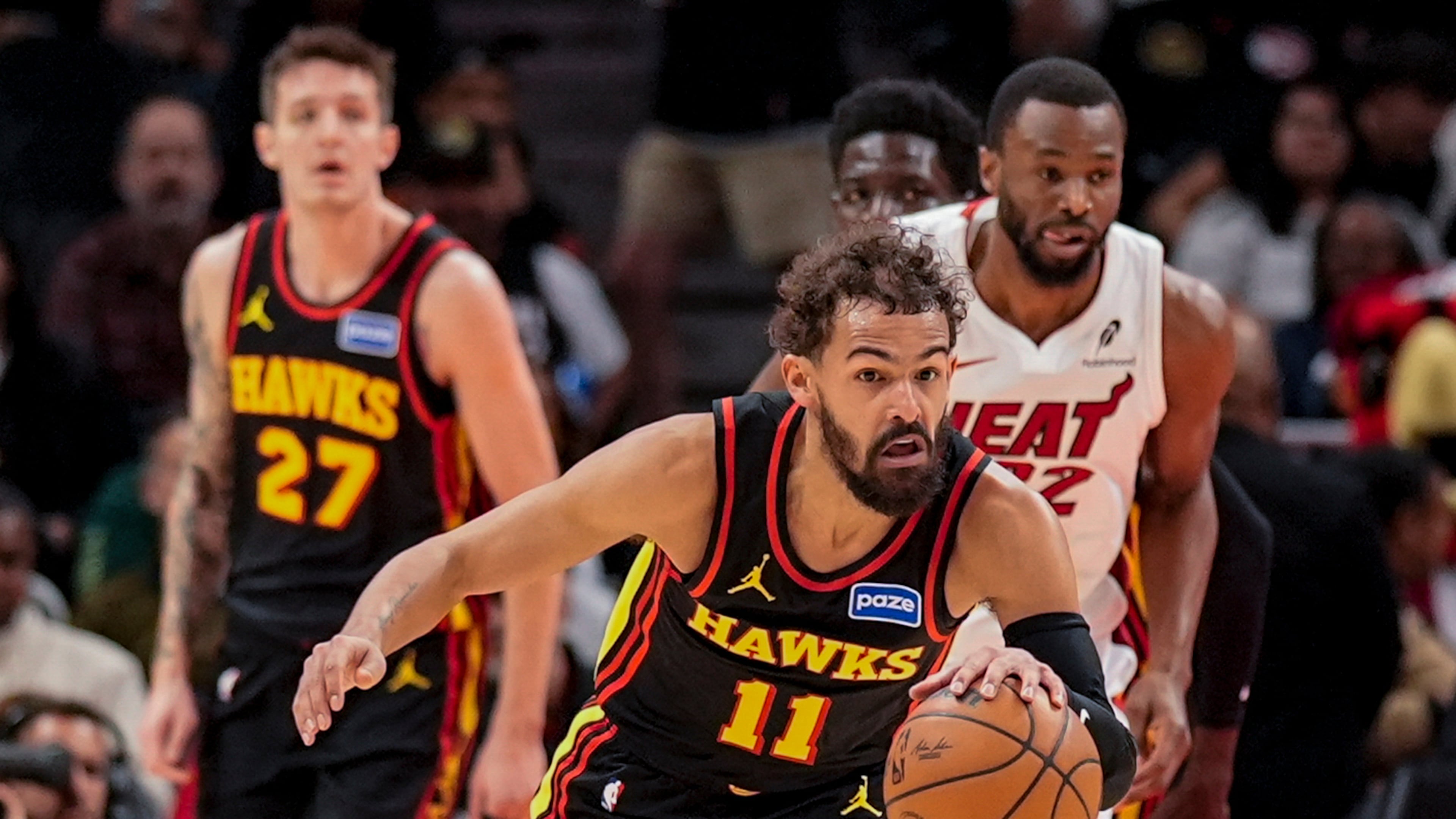 Atlanta Hawks guard Trae Young (11) drives against the Miami Heat during the first half of an NBA basketball game, Friday, Dec. 26, 2025, in Atlanta. (AP Photo/Mike Stewart)