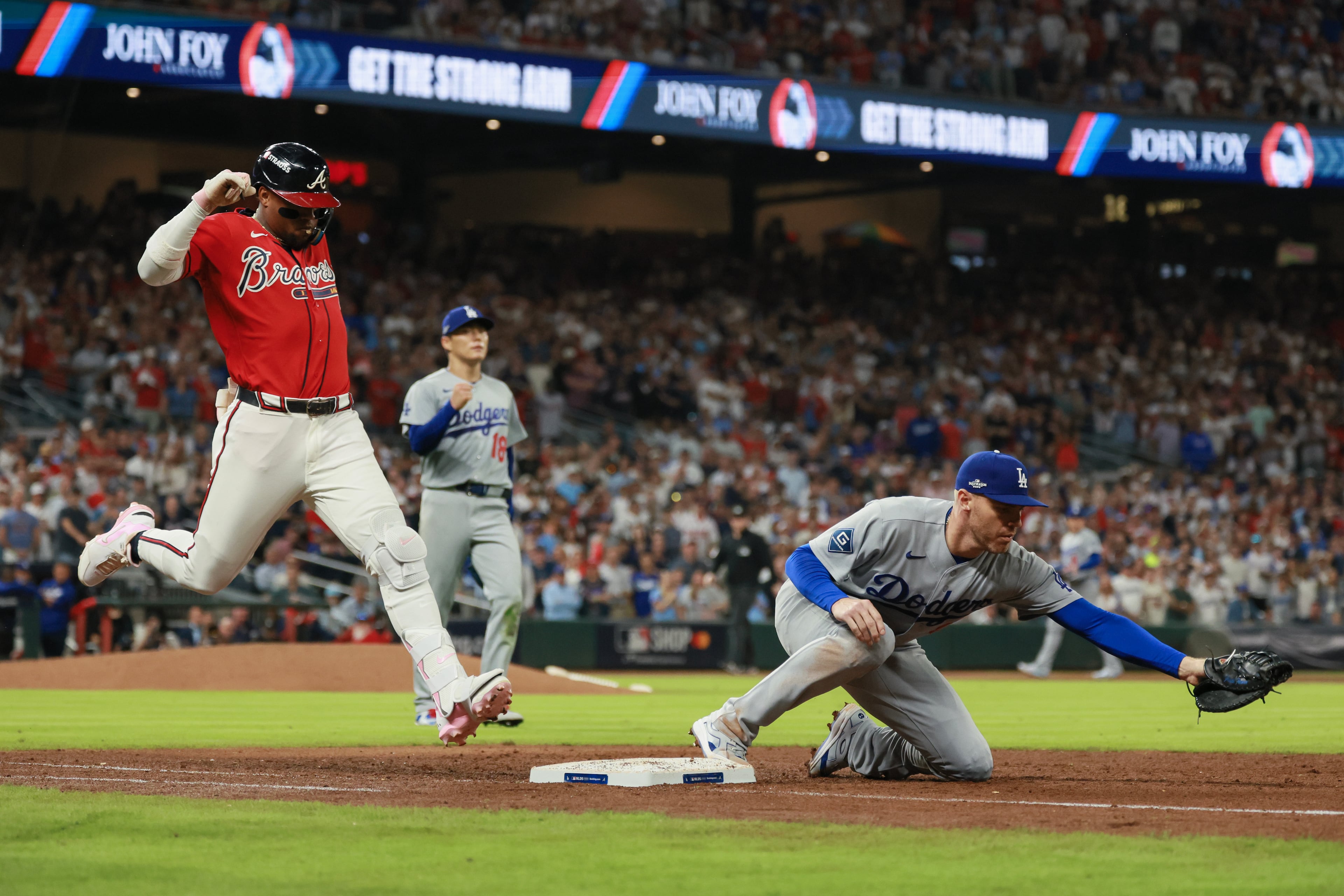 Atlanta Braves designated hitter Ronald Acuña Jr. (13) grounds out against Los Angeles Dodgers first baseman Freddie Freeman (5) during the fifth inning of Game 3 of the MLB National League Division Series between the Atlanta Braves and the Los Angeles Dodgers, Tuesday, Oct. 6, 2026, in Atlanta. (Jason Getz/AJC)