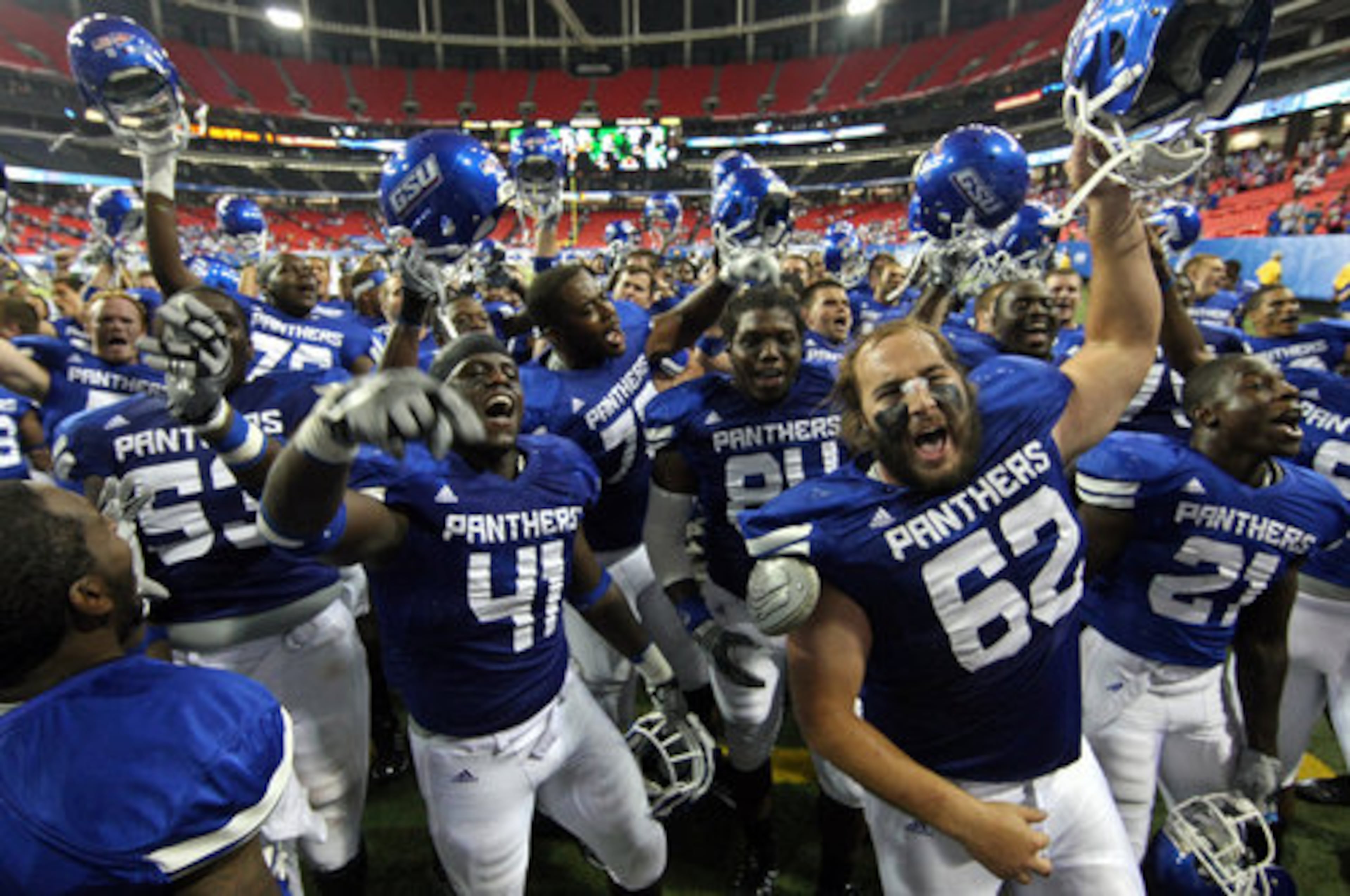 Georgia State University center Ben Jacoby (62, right) leads the team in the fight son as they sing with the marching band after their 41-7 win over Shorter College for their first ever win in the Georgia Dome Thursday night in Atlanta, Ga., Sept. 2, 2010.
