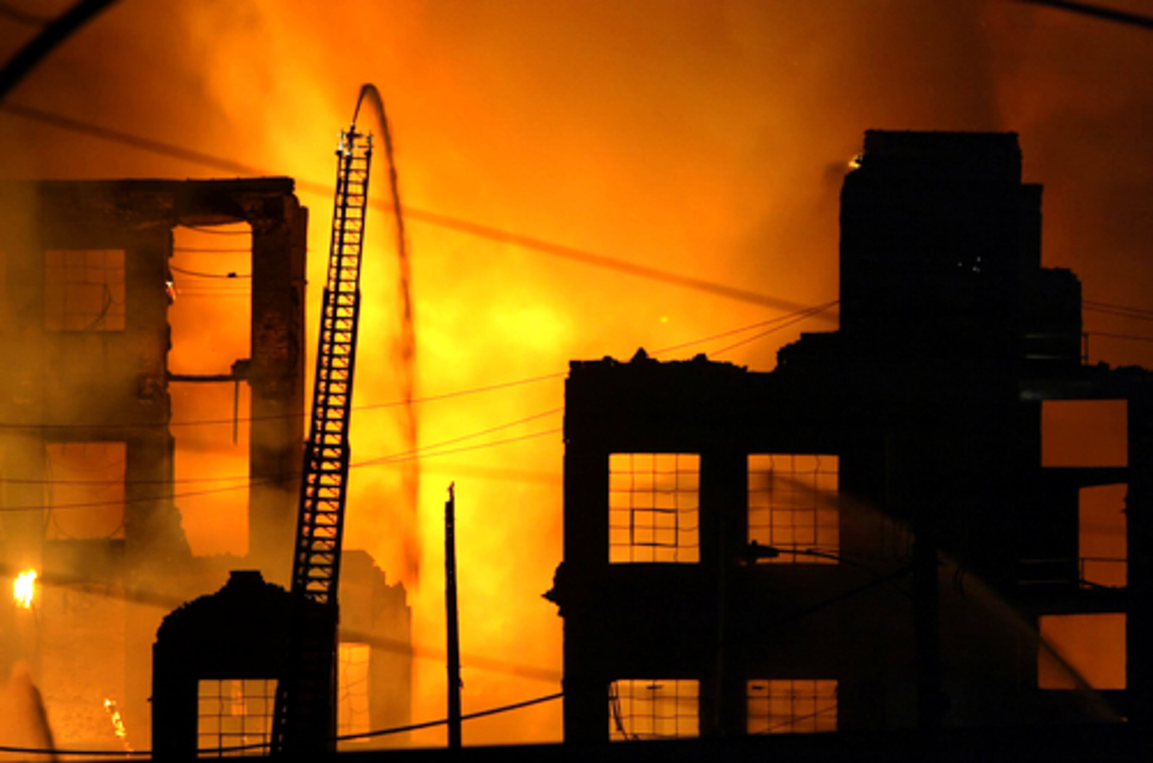Firefighters battle a seven alarm fire in a Philadelphia warehouse on Monday. Nearby homes were evacuated because of flying embers but firefighters were able to keep the flames from spreading to those structures. Authorities report no injuries at this time.