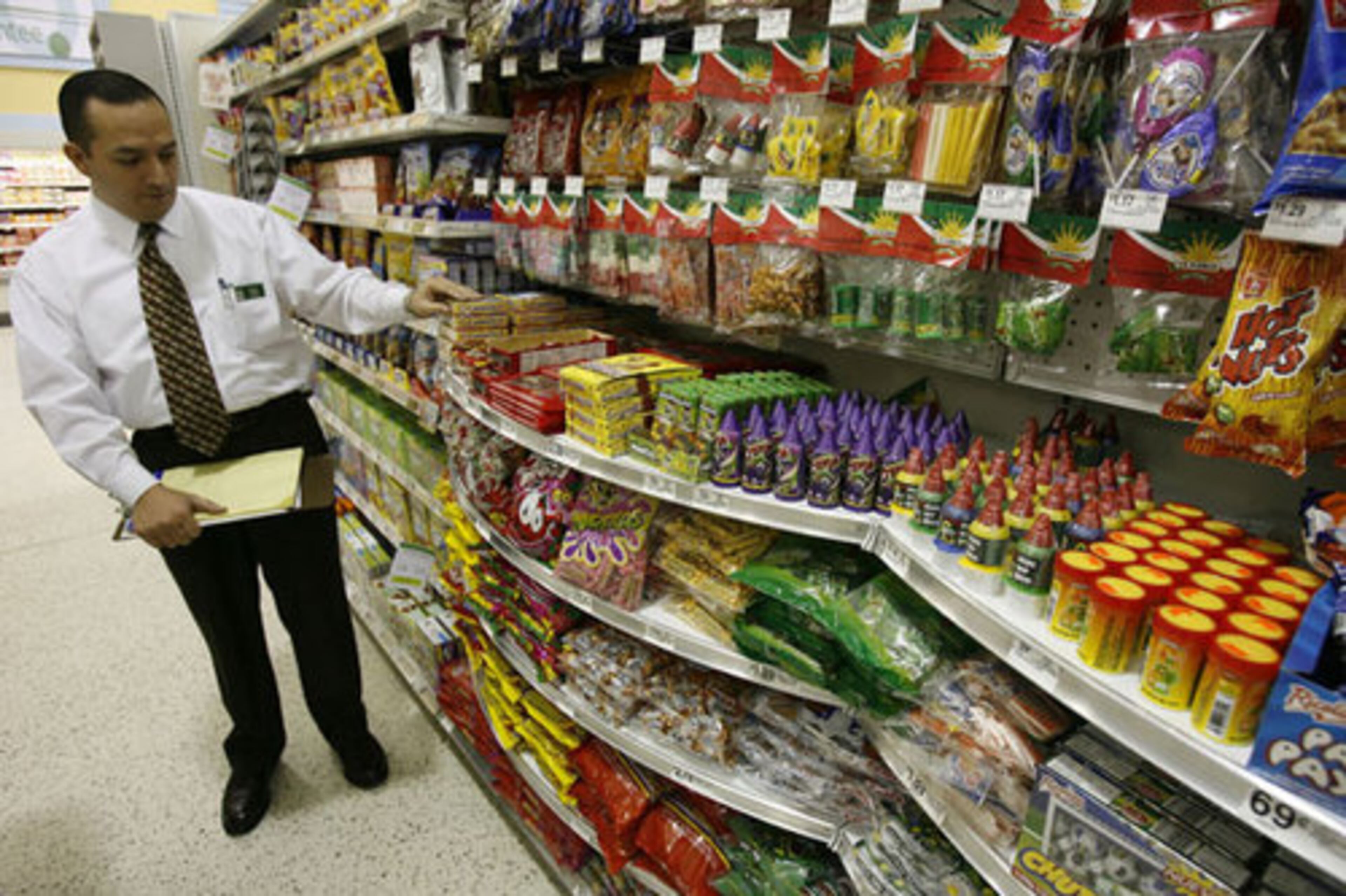 Store manager Marco Guillen shows some of the candy products from Mexico.