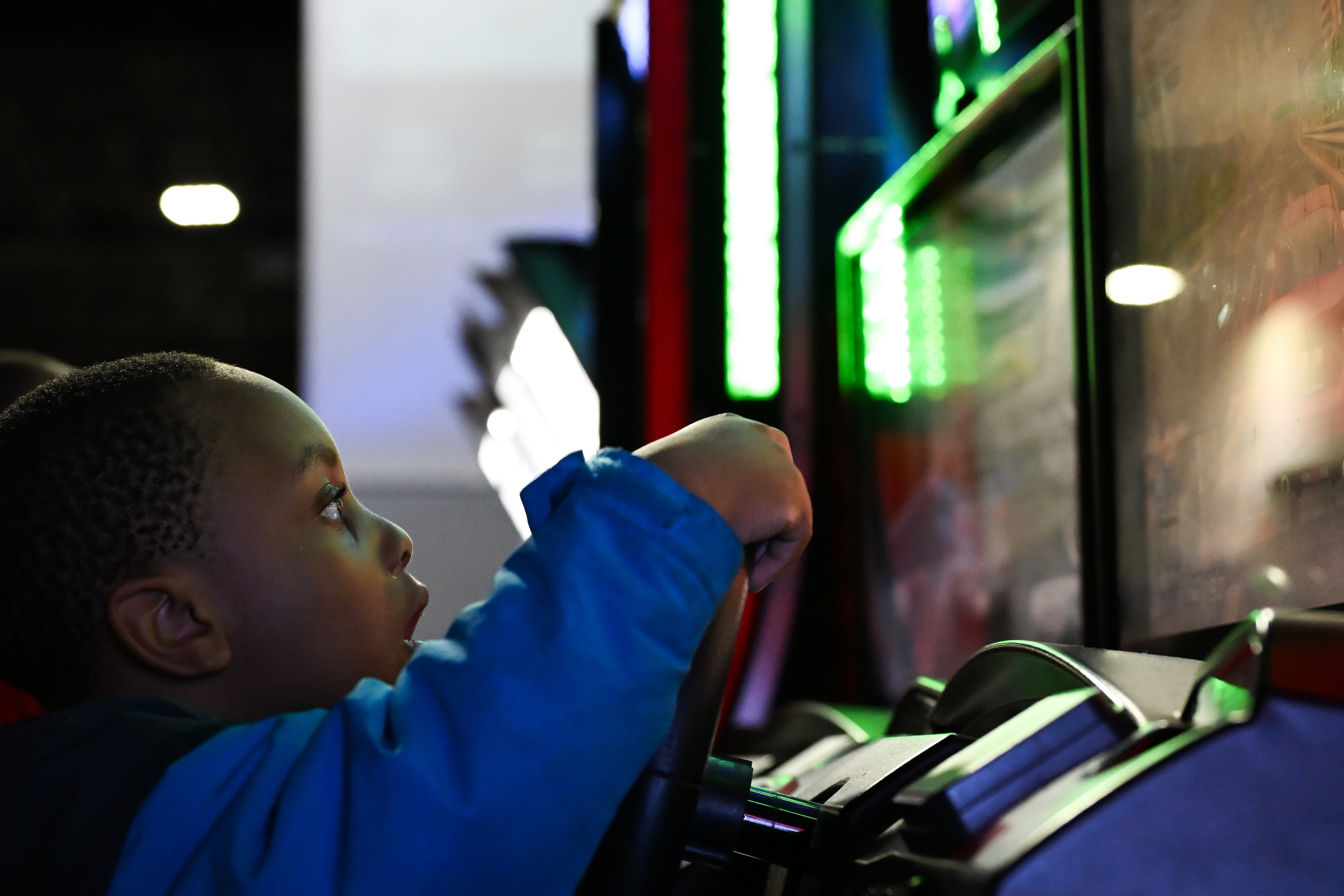 Jay Beasley plays an arcade racing game during MomoCon at the Georgia World Congress Center in Atlanta on Friday, May 22, 2026. MomoCon offers attendees access to a range of video and board games. (Tyler Sun for the AJC)
