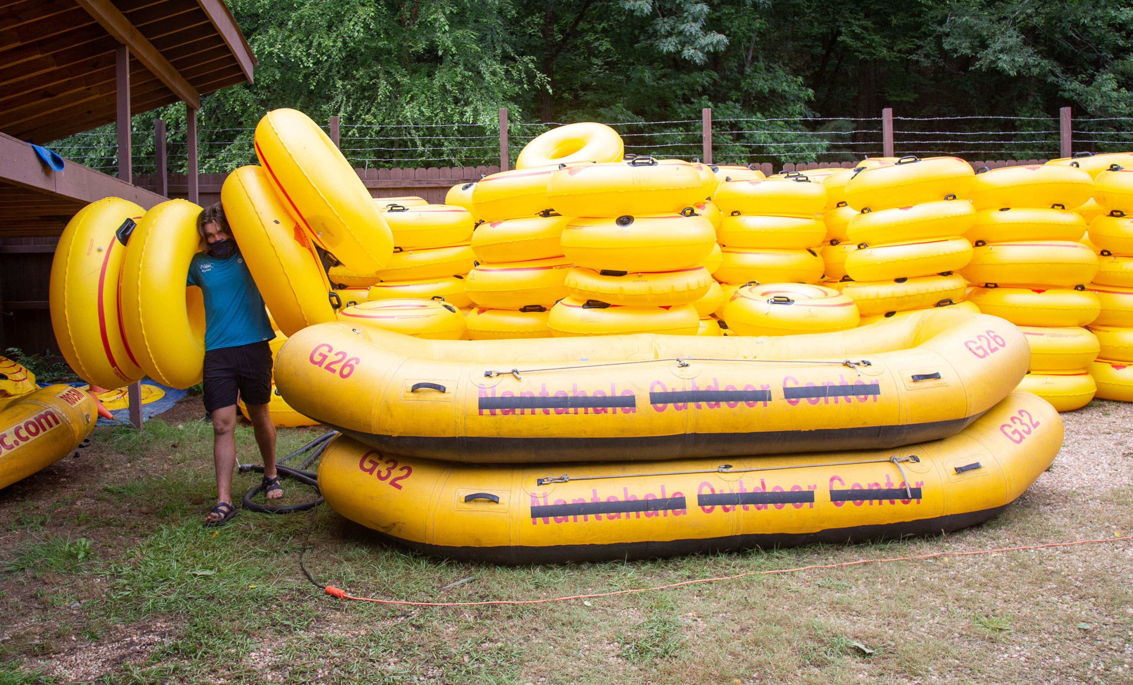 Nantahala Outdoor Center employee Will Smith grabs inner tubes for a customer at the Powers Island Park in Sandy Springs on Sunday, June 28, 2020. STEVE SCHAEFER FOR THE ATLANTA JOURNAL-CONSTITUTION