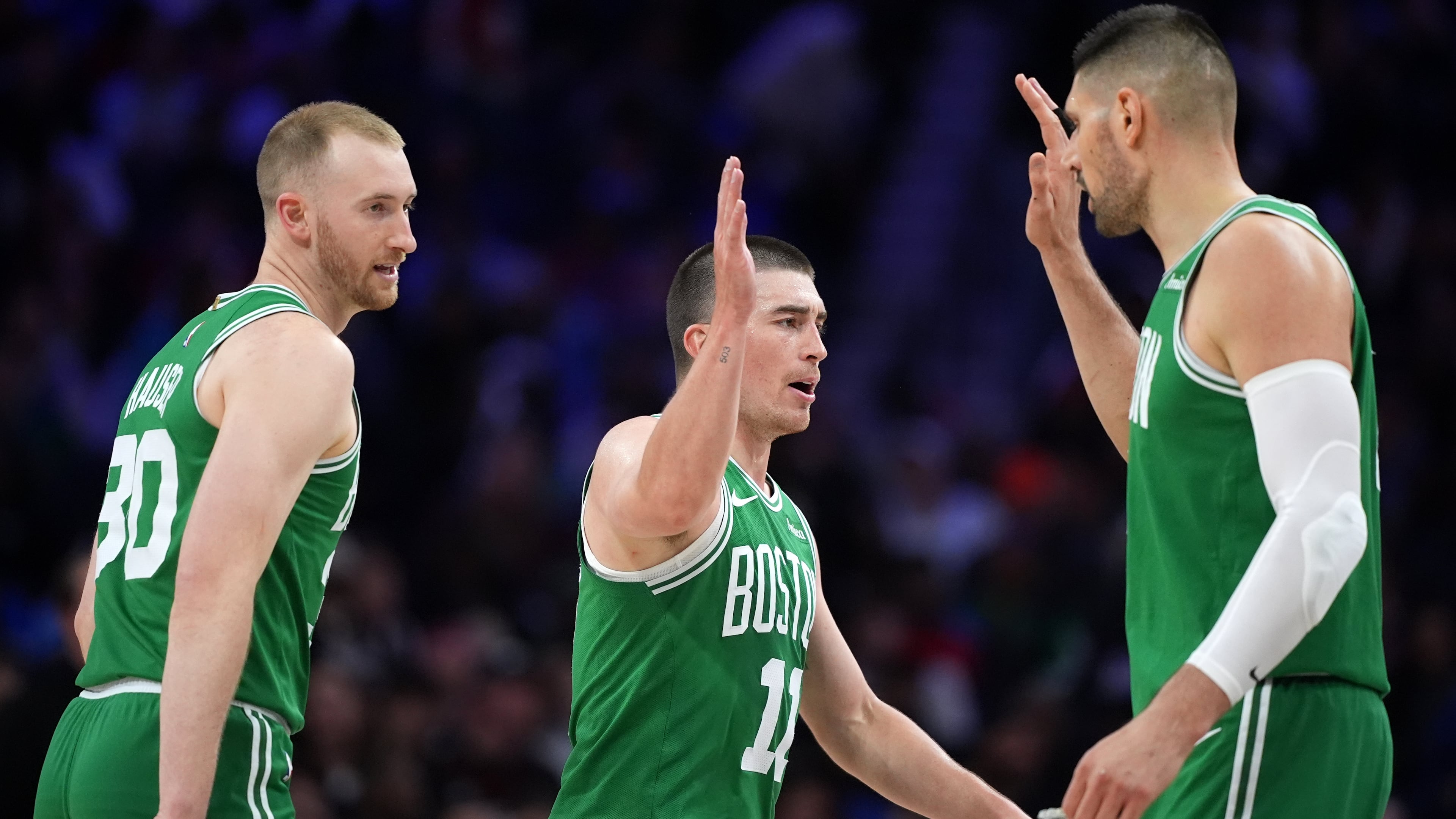 Boston Celtics' Sam Hauser, from left, Payton Pritchard and Nikola Vucevic react during the first half of Game 4 against the Philadelphia 76ers in a first-round NBA basketball playoffs series Sunday, April 26, 2026, in Philadelphia. (AP Photo/Matt Slocum)