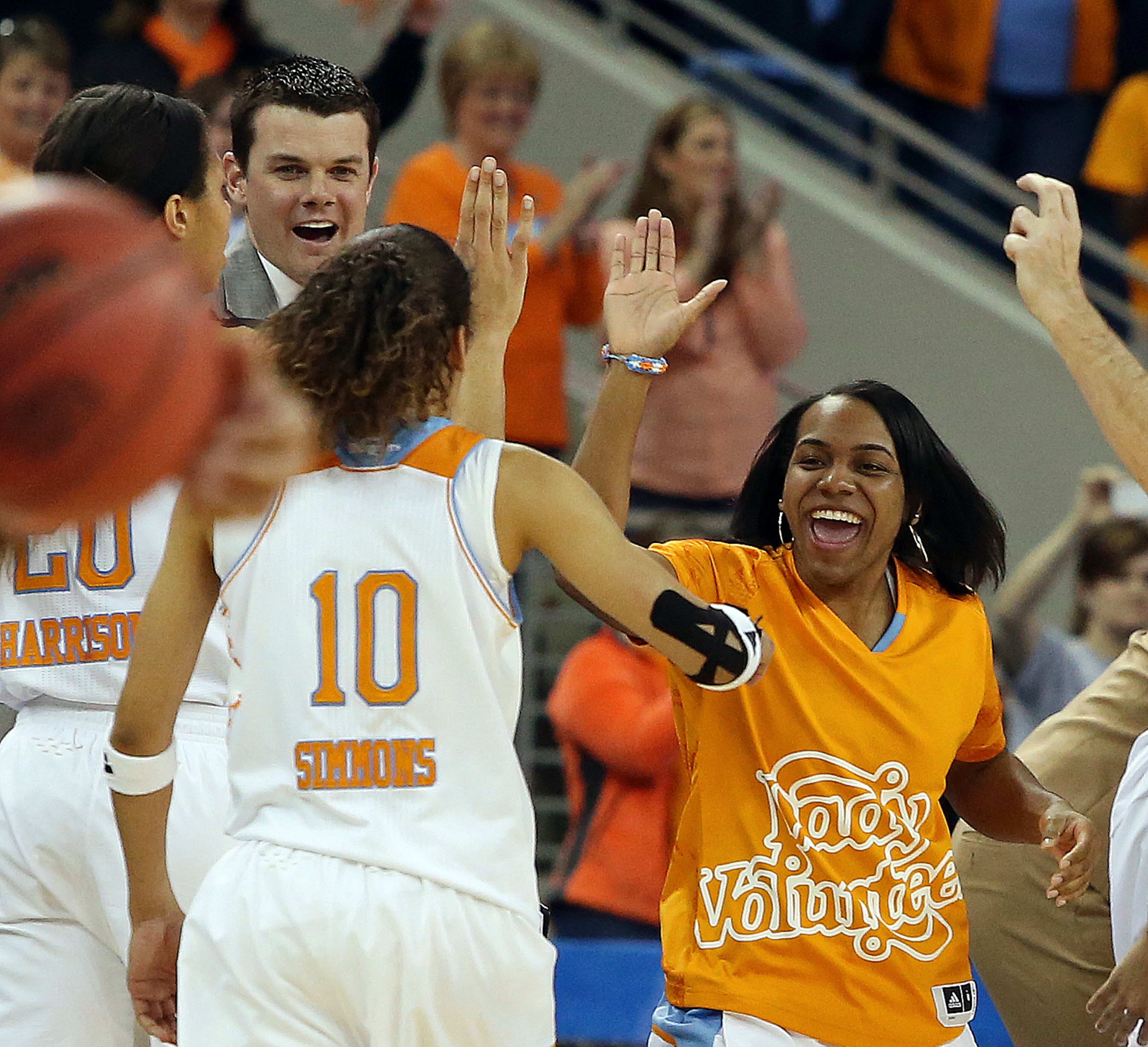 Injured Tennessee guard Ariel Massengale, right, celebrates with Tennessee guard Meighan Simmons (10) in the second half of an NCAA college basketball game against Kentucky in the finals of the Southeastern Conference women's basketball tournament Sunday, March 9, 2014, in Duluth. Tennessee won 71-70. (AP Photo/Jason Getz)